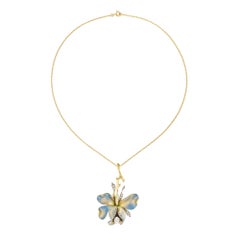 An Art Nouveau enamel and diamond set flower brooch/pendant
