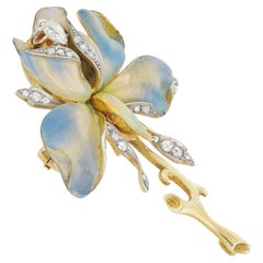 An Art Nouveau enamel and diamond set flower brooch/pendant