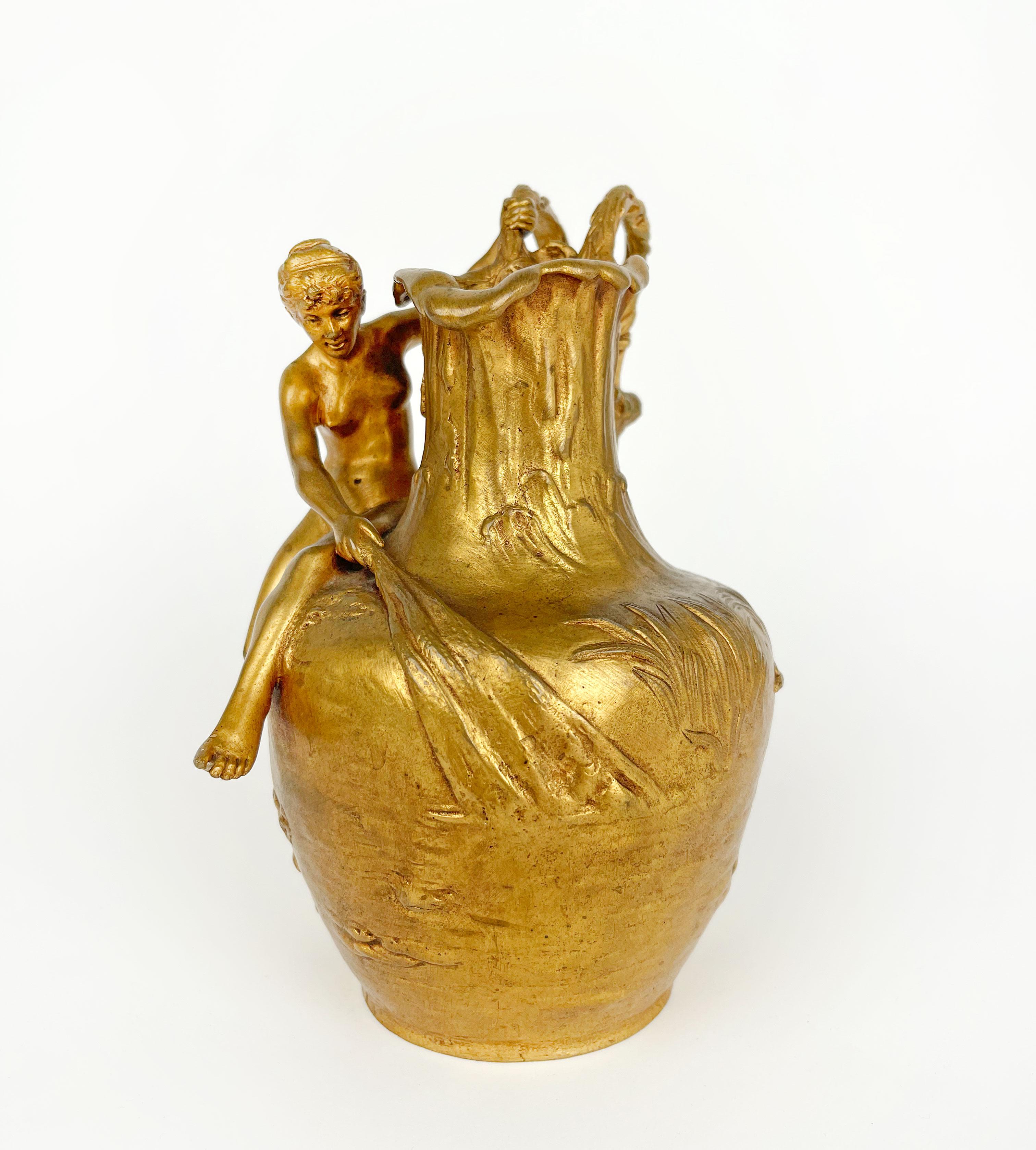 An Art Nouveau gilt bronze Ewer by Alexandre Vibert, France, Circa 1900
Modeled and cast as a naked woman drawing in a fishing net, with tree form handle.

Alexandre Vibert (1847-1909) was both a sculptor and a medallist. He participated in the