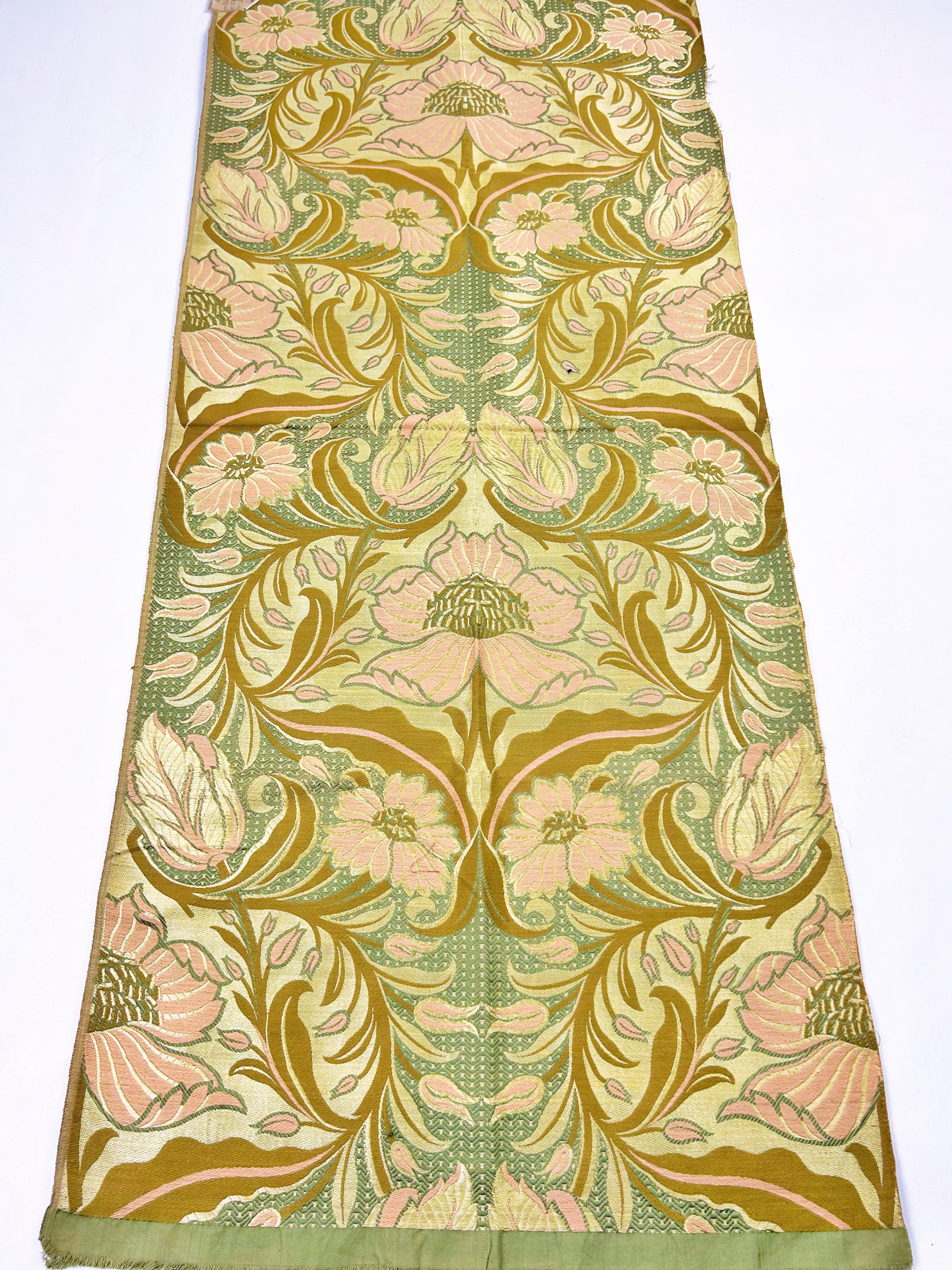 Circa 1900 France
A length of silk and cotton Jacquard fabric dating from the Art Nouveau period in the early 20th century. Large, orderly pattern with large floral motifs in shades of cream, pale pink, and light brown on a gray-green background.