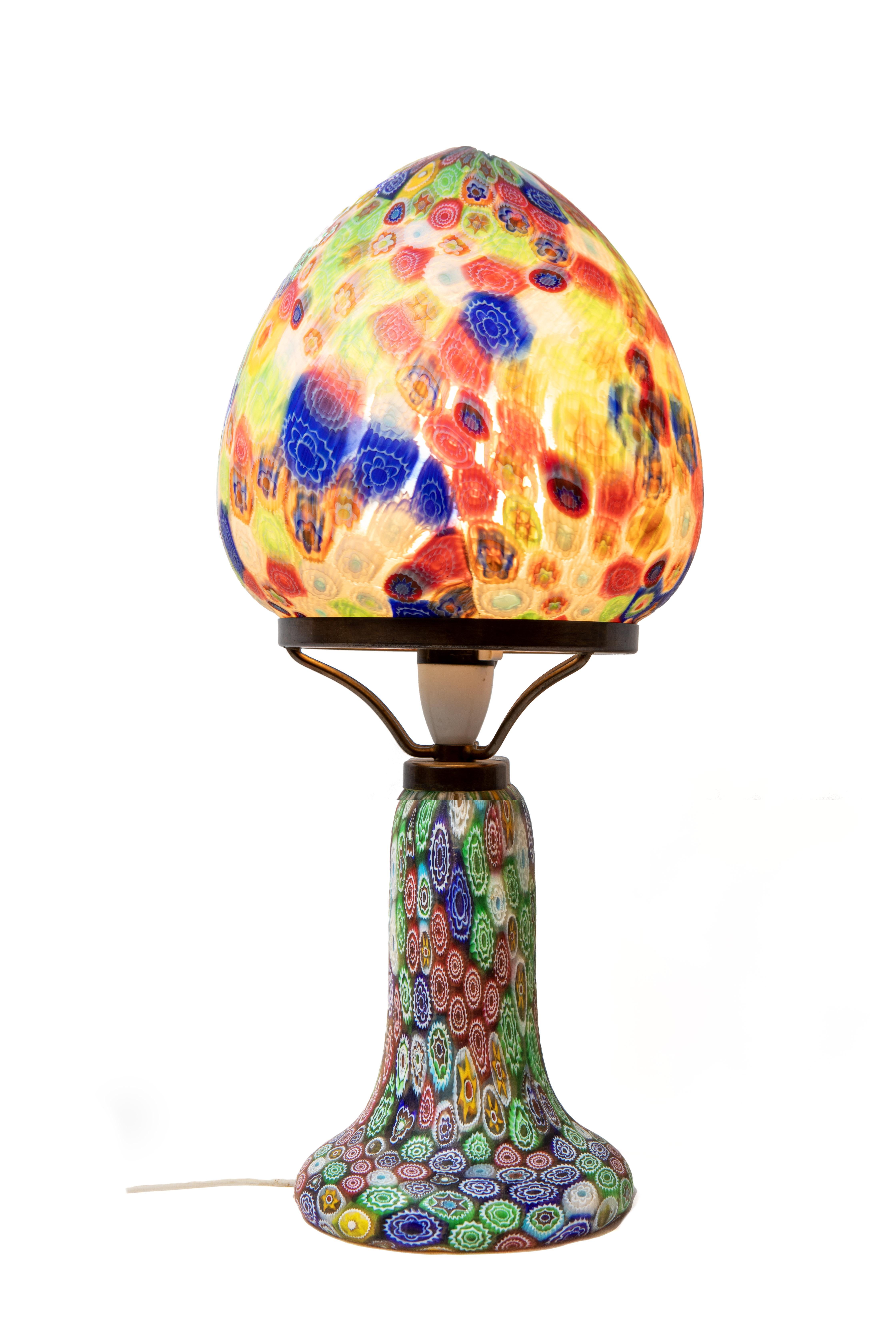 The glass is adorned in the enchanting Millefiori pattern comprising of two pieces seamlessly supported by an elegant metal framework. Fitted for electricity. 

Fratelli Toso was one of the leading art glass manufacturers of Murano in the 20th
