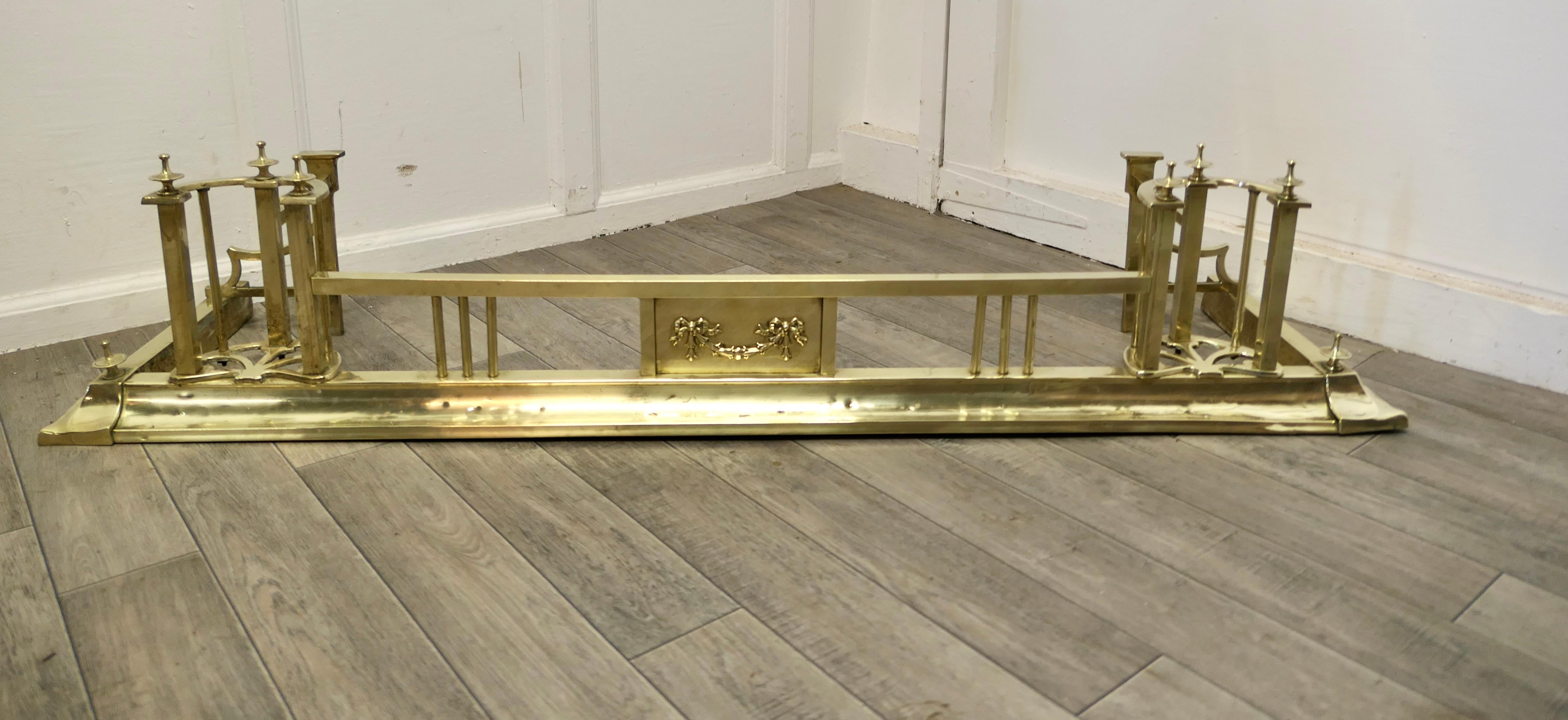An Art Nouveau Victorian brass fender 

This is a very attractive Brass Fender it has a small rail to the front in the Art Nouveau style with larger decoration at the sides
The Fender is in good Condition it is 11” high, 53” long and 14”