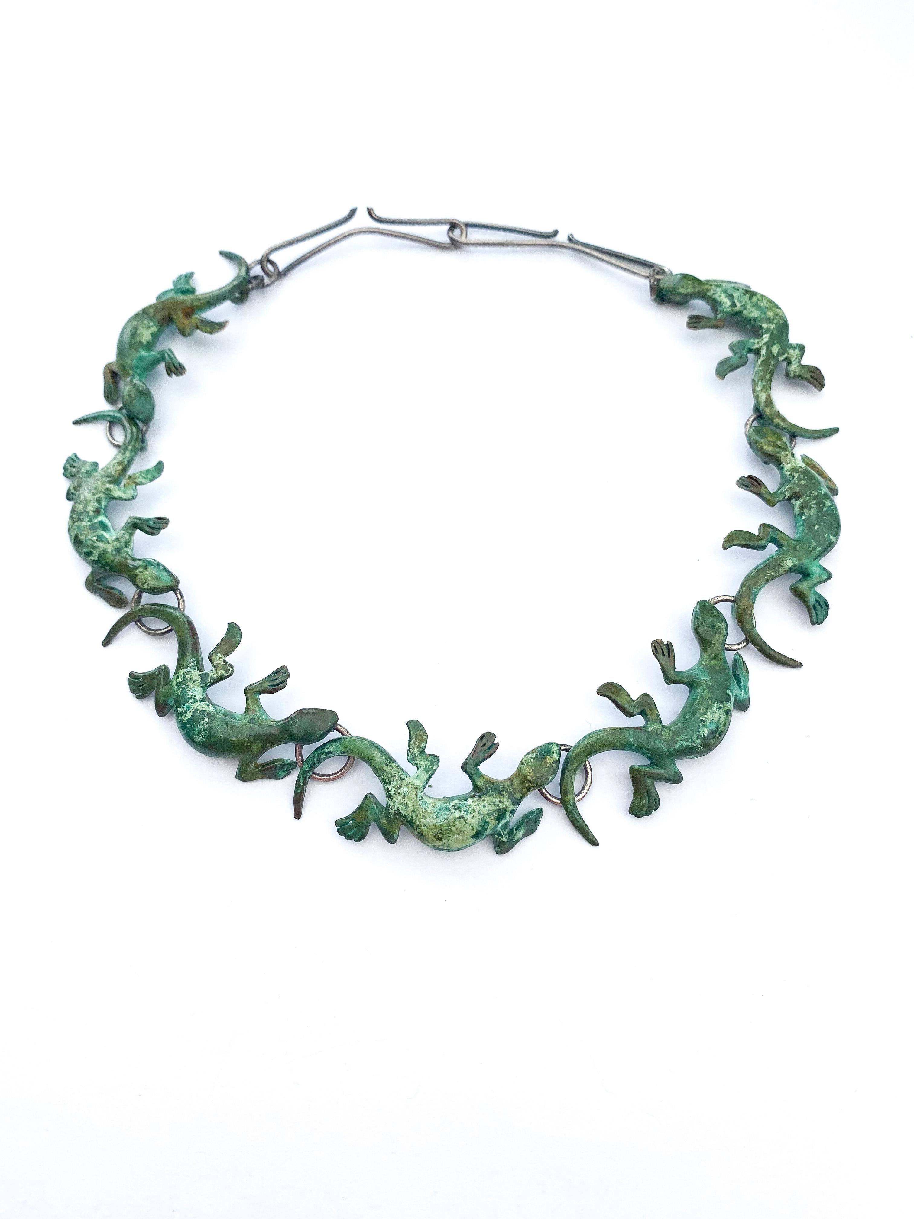 An unusual and whimsical design of salamanders, the motif repeated seven times throughout the necklace. The designer or maker, and country,  is unknown but it would seem to be a one off piece, the individual 'salamanders' are cast, then assembled by