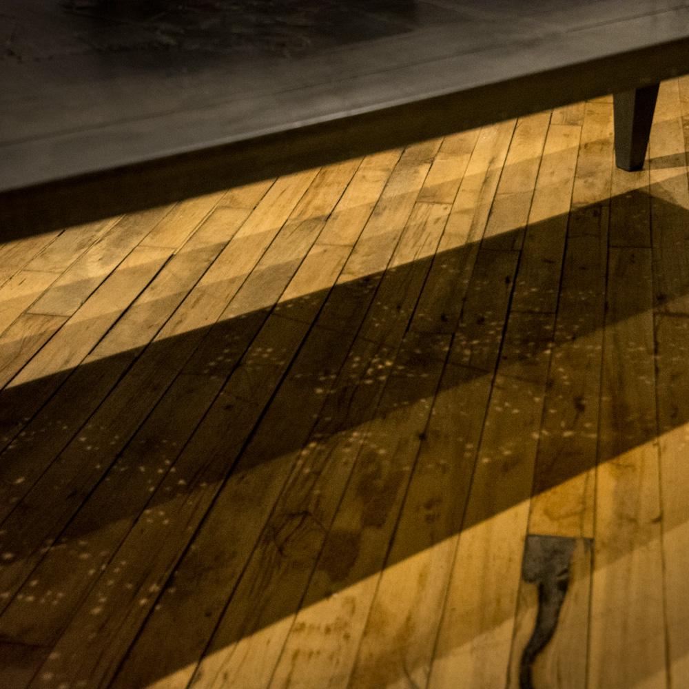 An artist designed metal clad silver color coffee table with holes in top. Circa 1980. The table was designed so that when light shines from above and passes thru the holes in the top it casts an interesting pattern onto the floor below. Artist