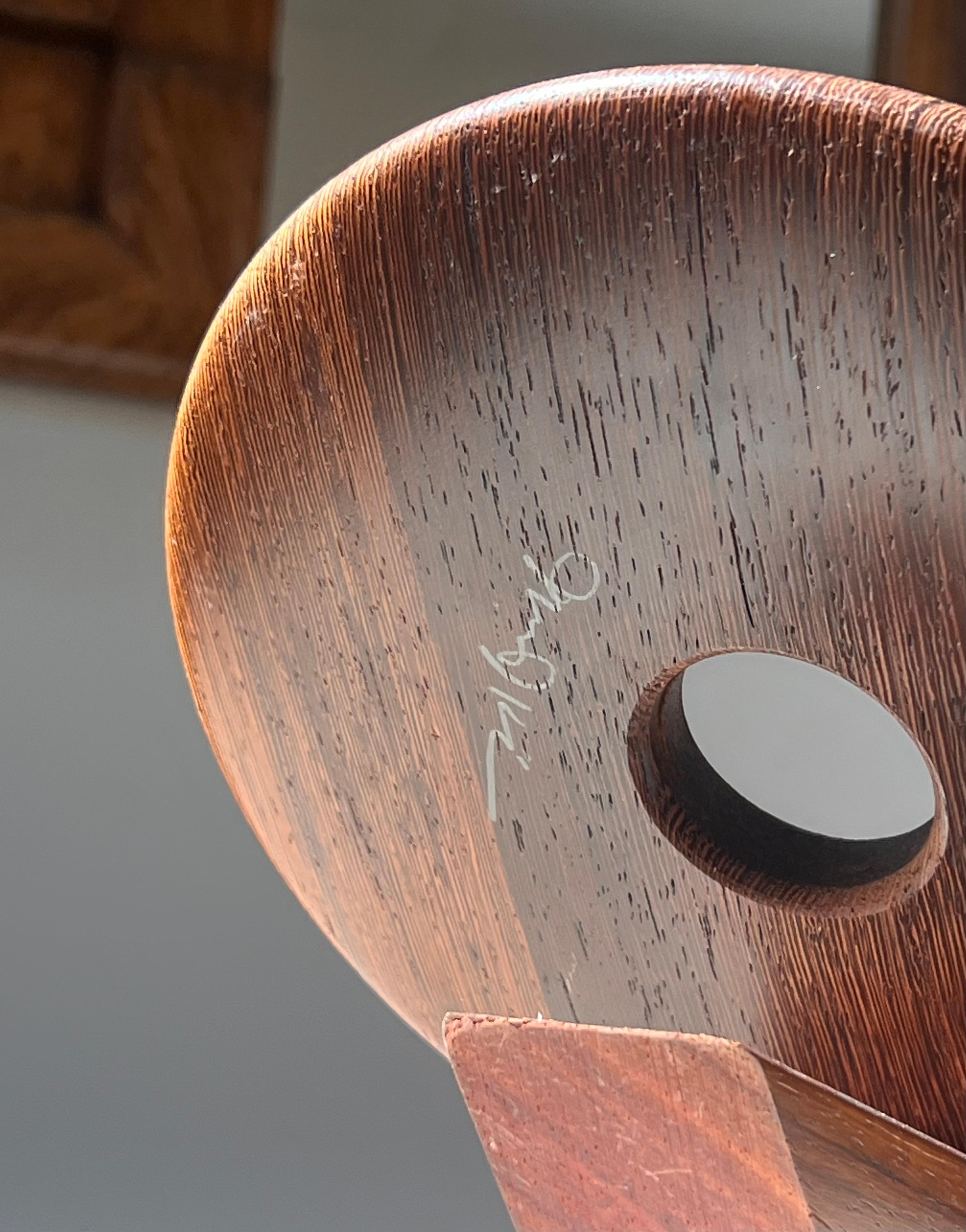 An artist-made Danish mid century teak wine holder, signed, mid 20th century 1