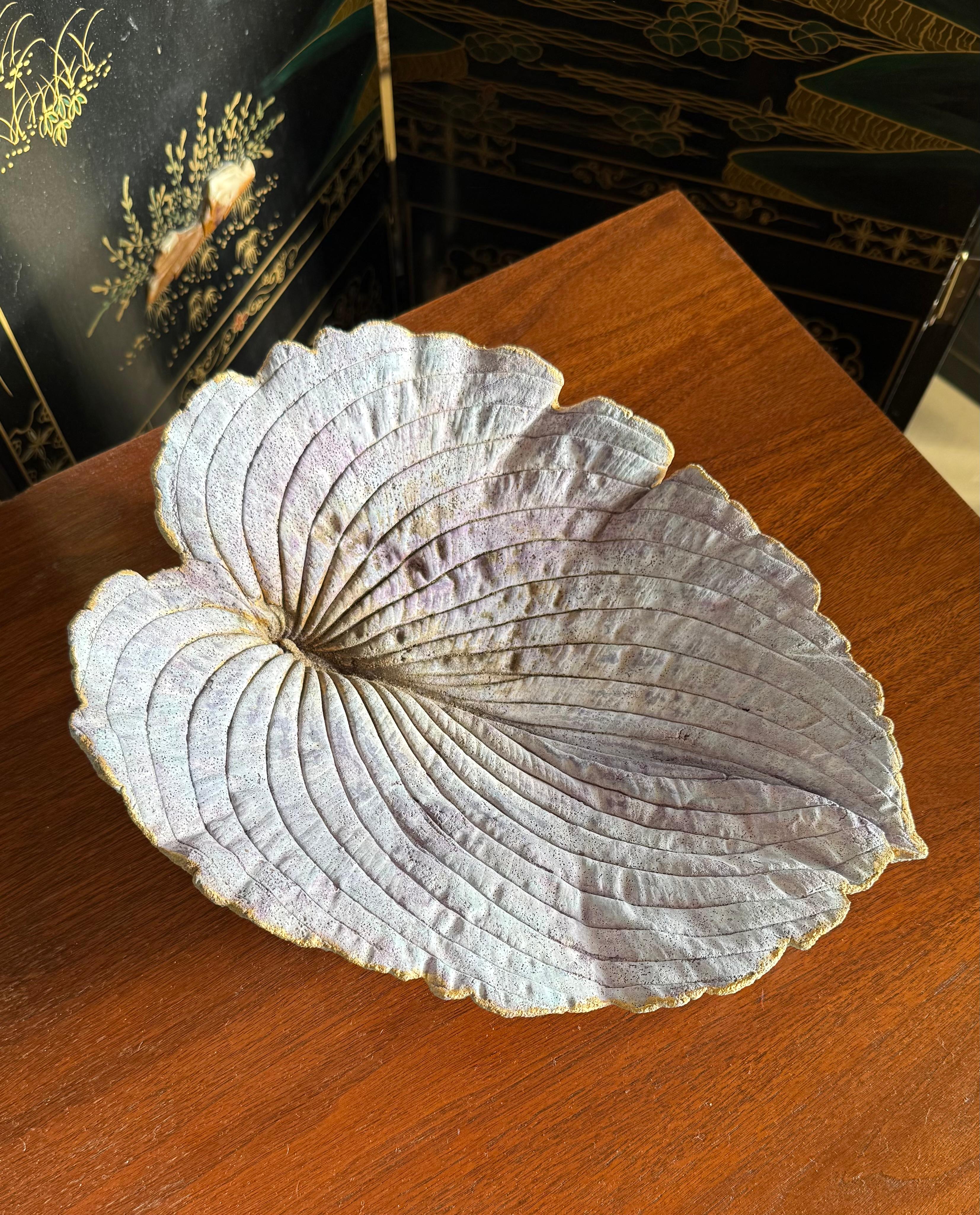 A lavender colored artist-made studio ceramic sculpture or platter depicting a large tropical leaf, signed on verso, 2013. Exquisite as a gift or for any discerning lover of ceramics. 