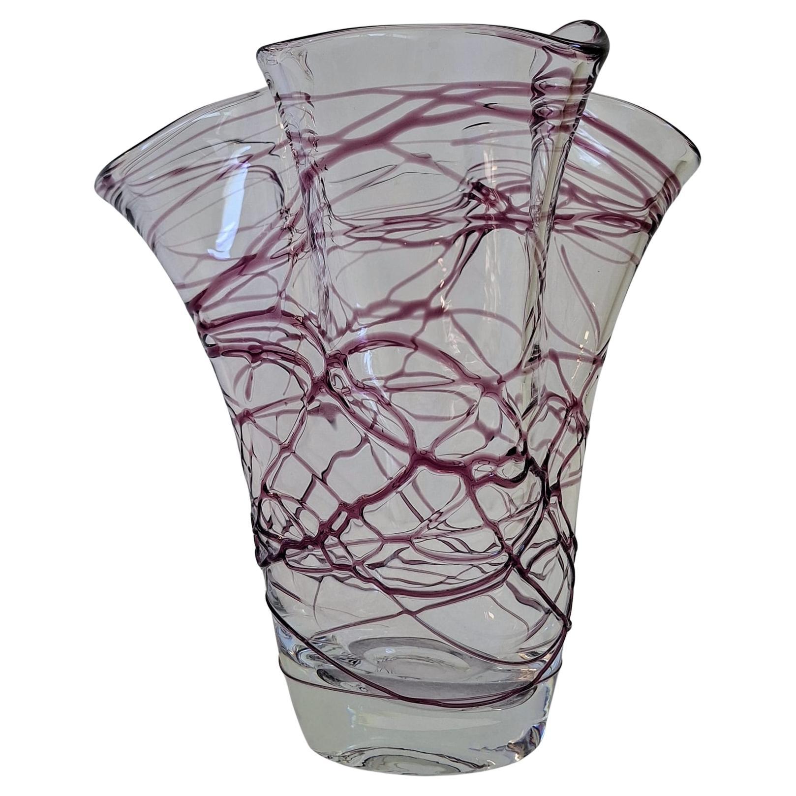 An artistic vase with irregular violet glass lines