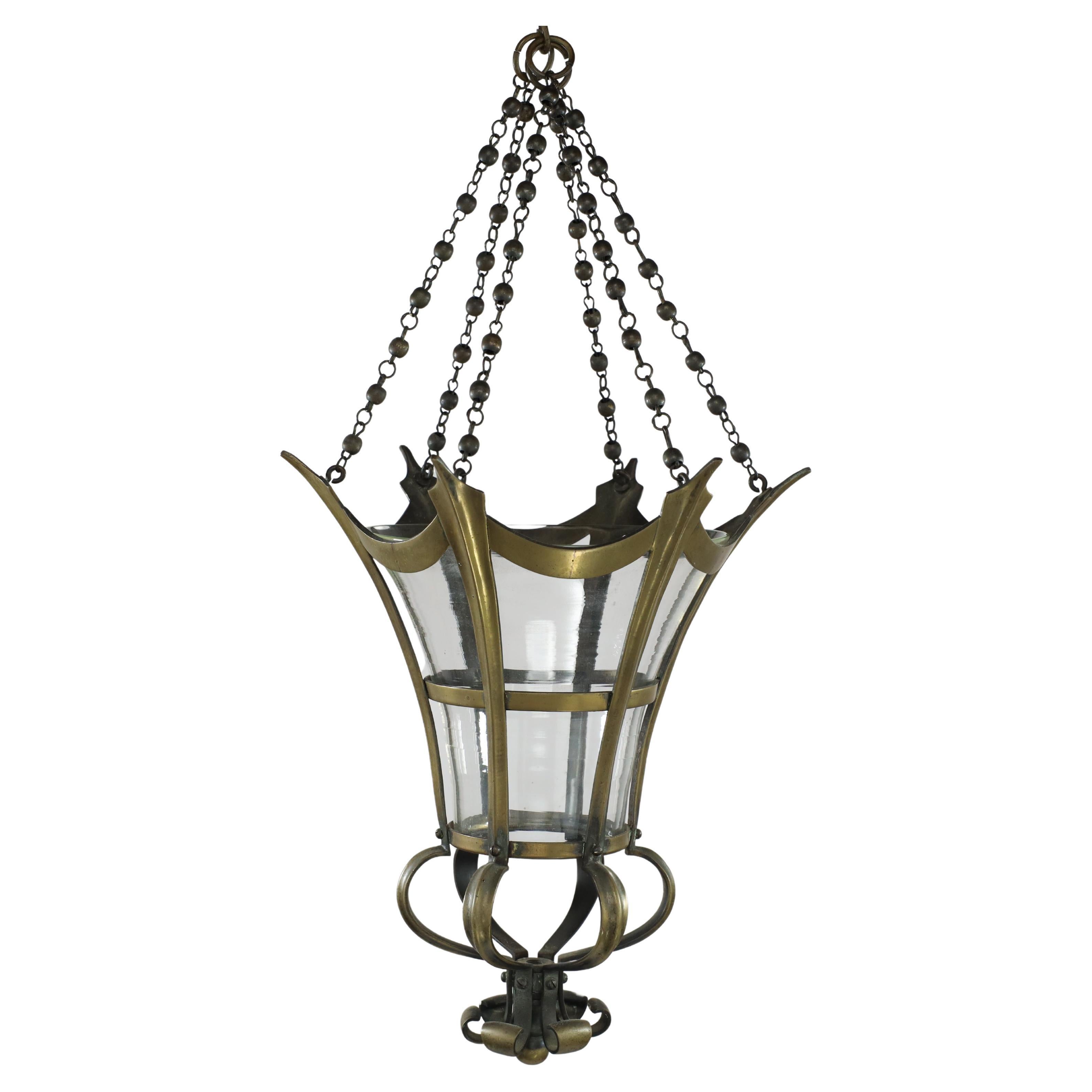 An Arts and Crafts brass conical shaped lantern with its original conical shade