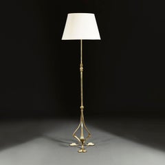 An Arts and Crafts Brass Floor Lamp With Tripod Base