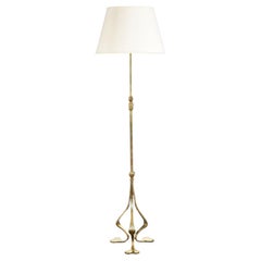 An Arts and Crafts Brass Floor Lamp With Tripod Base