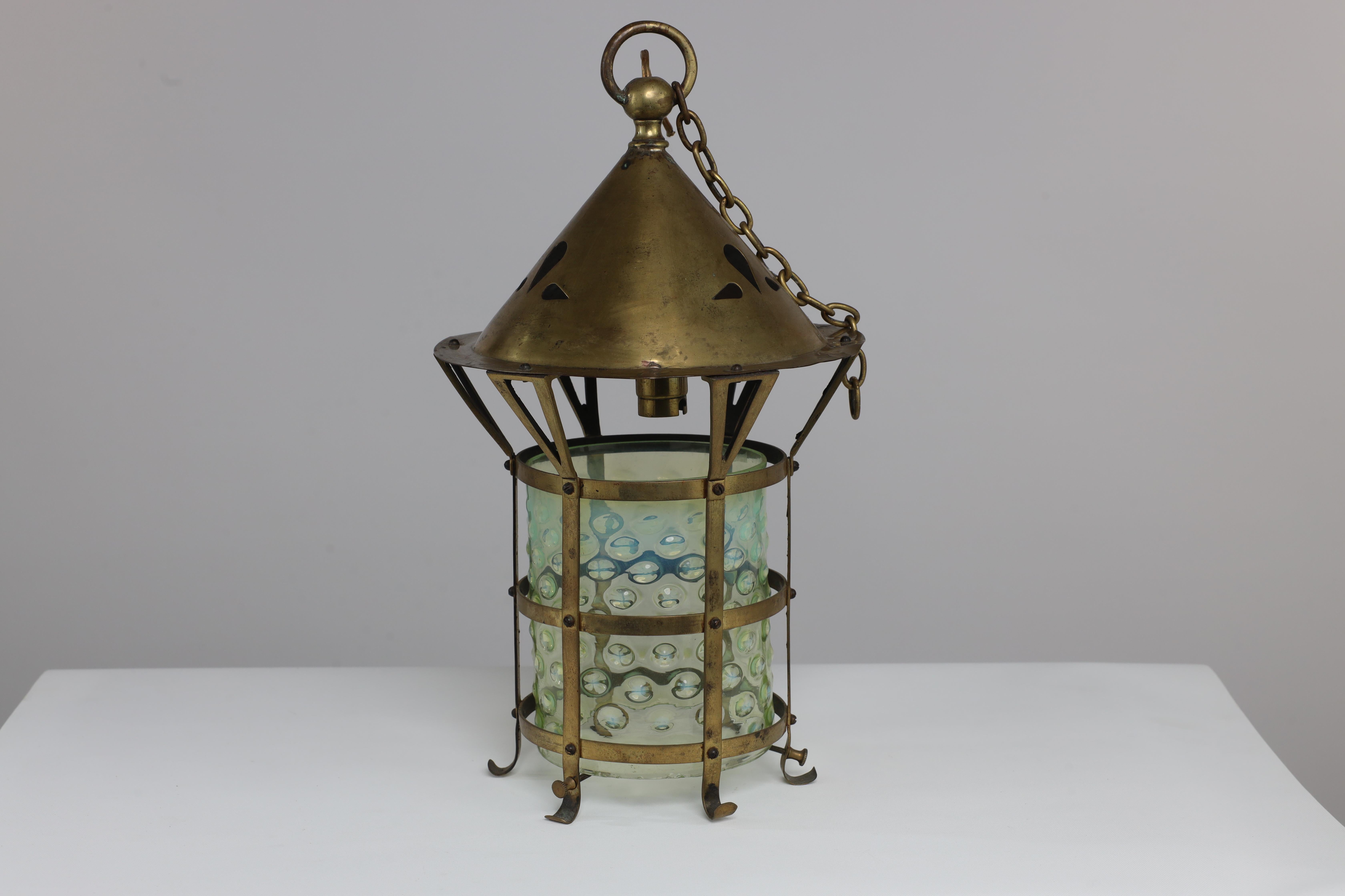 An Arts and Crafts brass lantern with the original bubble Vaseline shade. We will supply an original brass chain to hang this at any height.