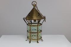 An Arts and Crafts brass lantern with the original bubble Vaseline glass shade.