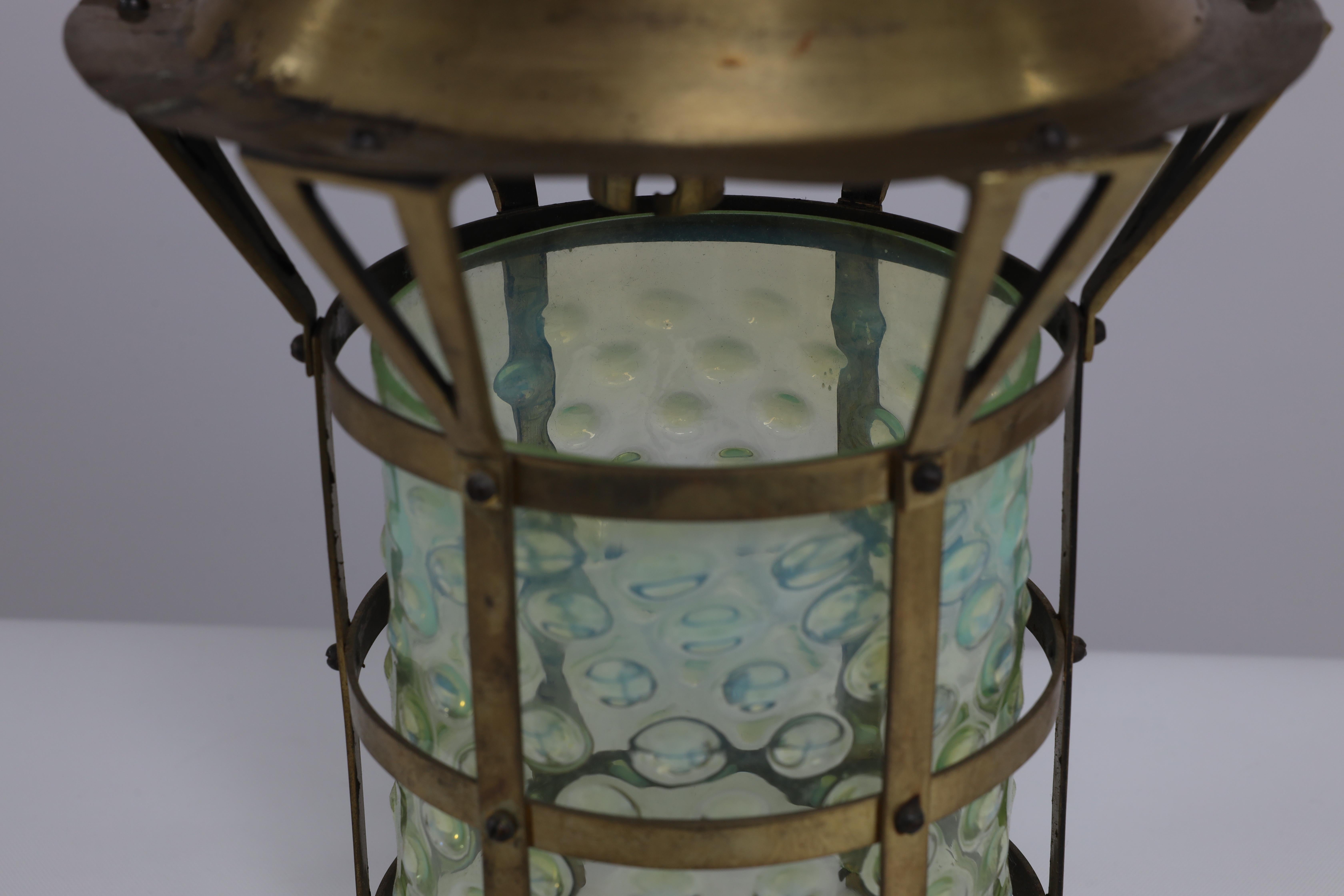 Early 20th Century An Arts and Crafts brass lantern with the original bubble Vaseline glass shade. For Sale