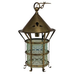An Arts and Crafts brass lantern with the original bubble Vaseline glass shade.