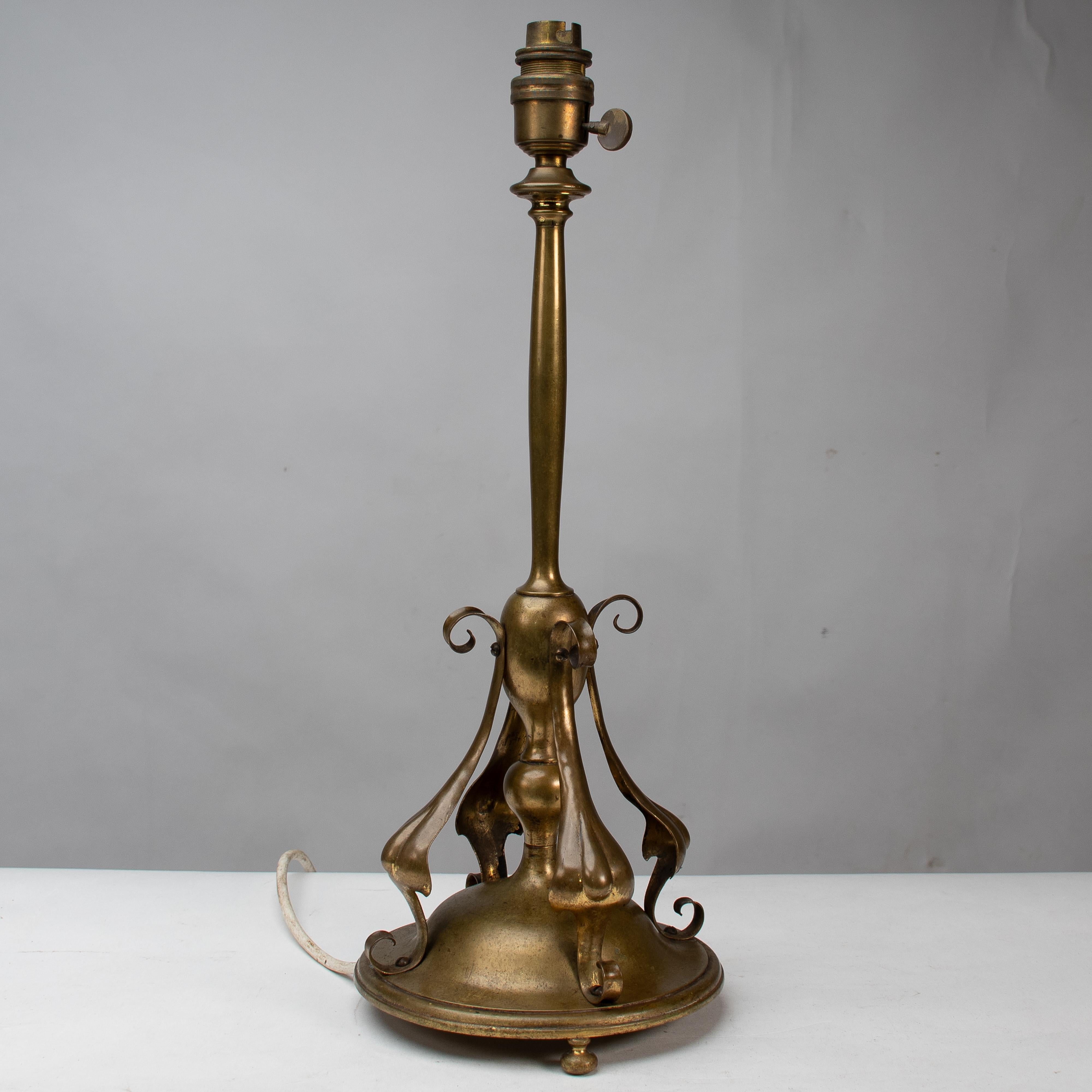 English An Arts and Crafts brass table lamp in the style of C F A Voysey For Sale