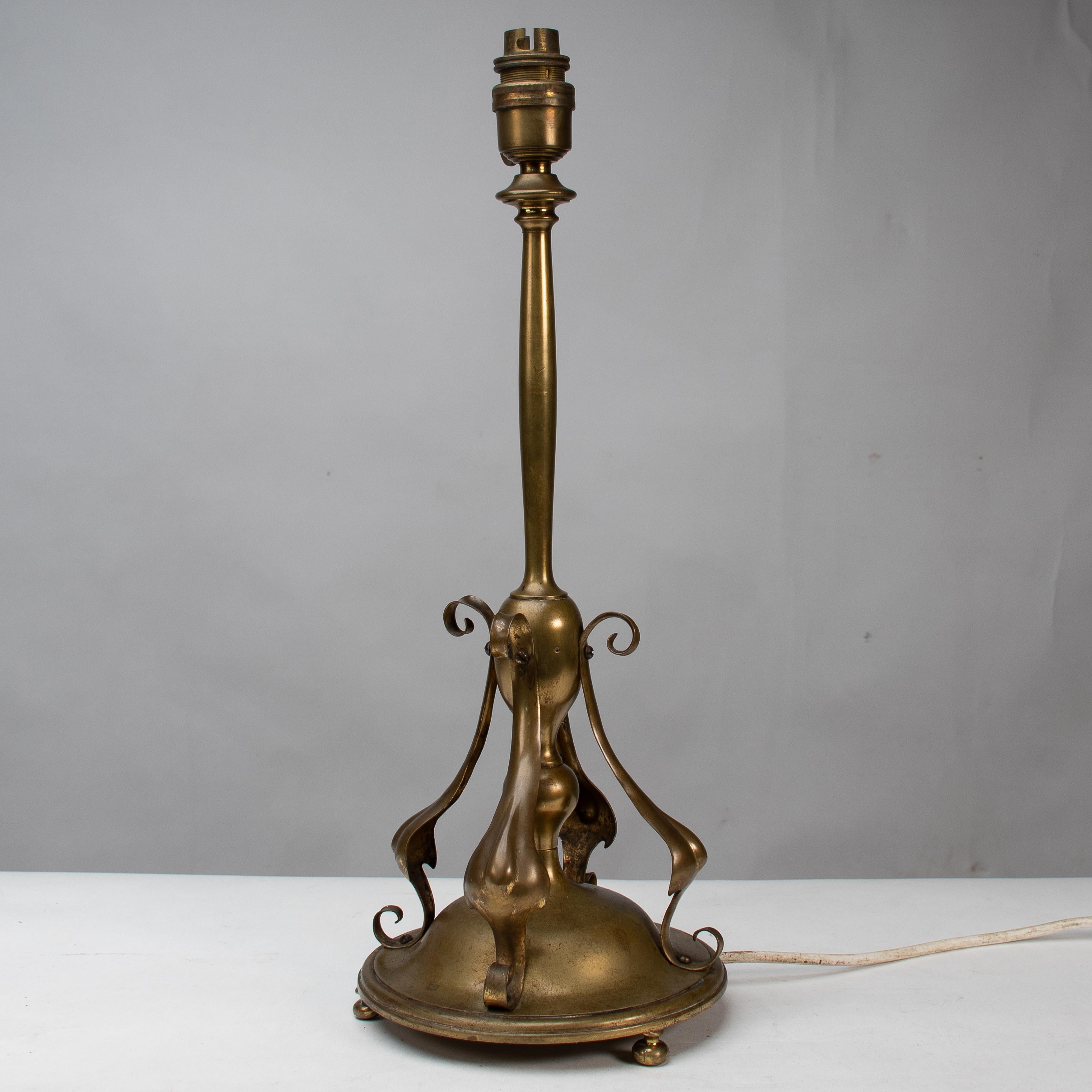 Early 20th Century An Arts and Crafts brass table lamp in the style of C F A Voysey For Sale