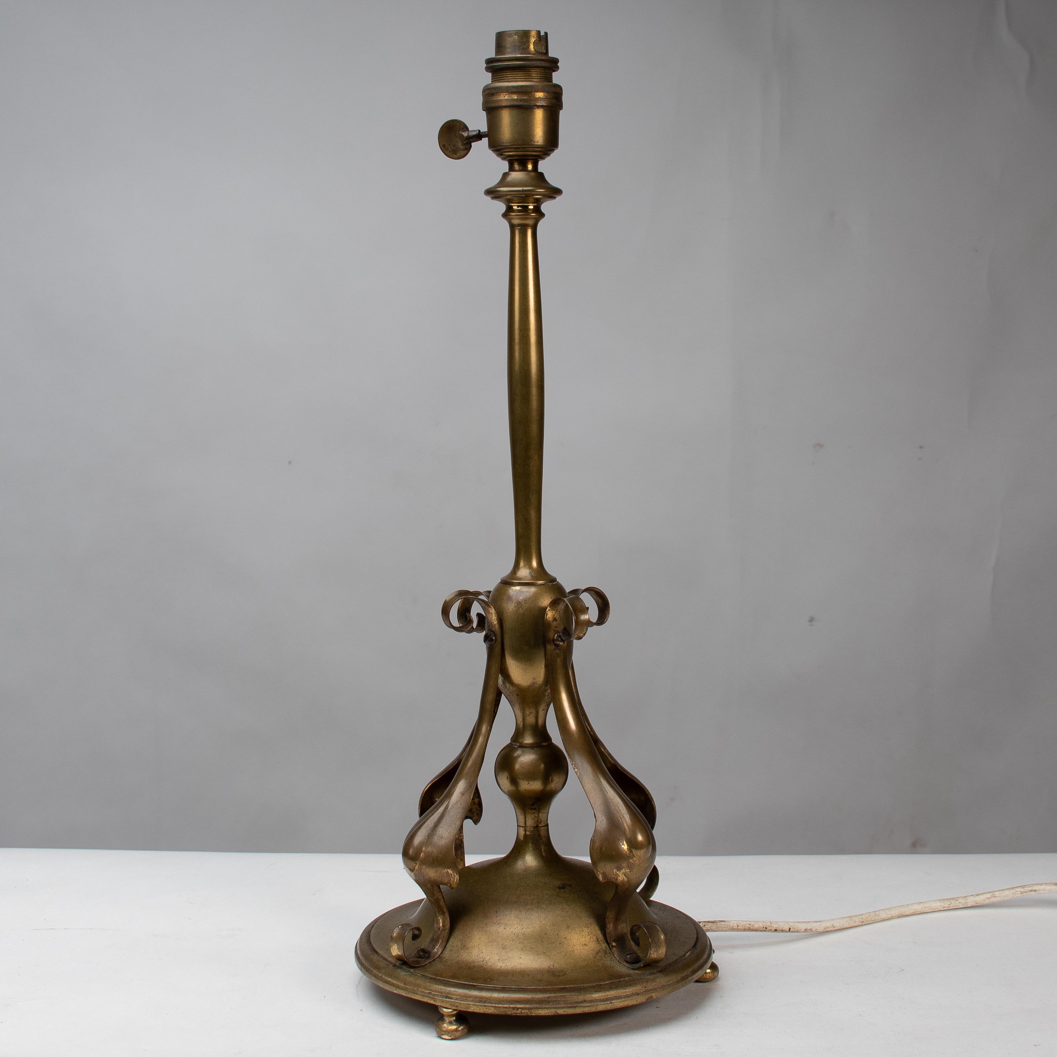 An Arts and Crafts brass table lamp in the style of C F A Voysey For Sale 1