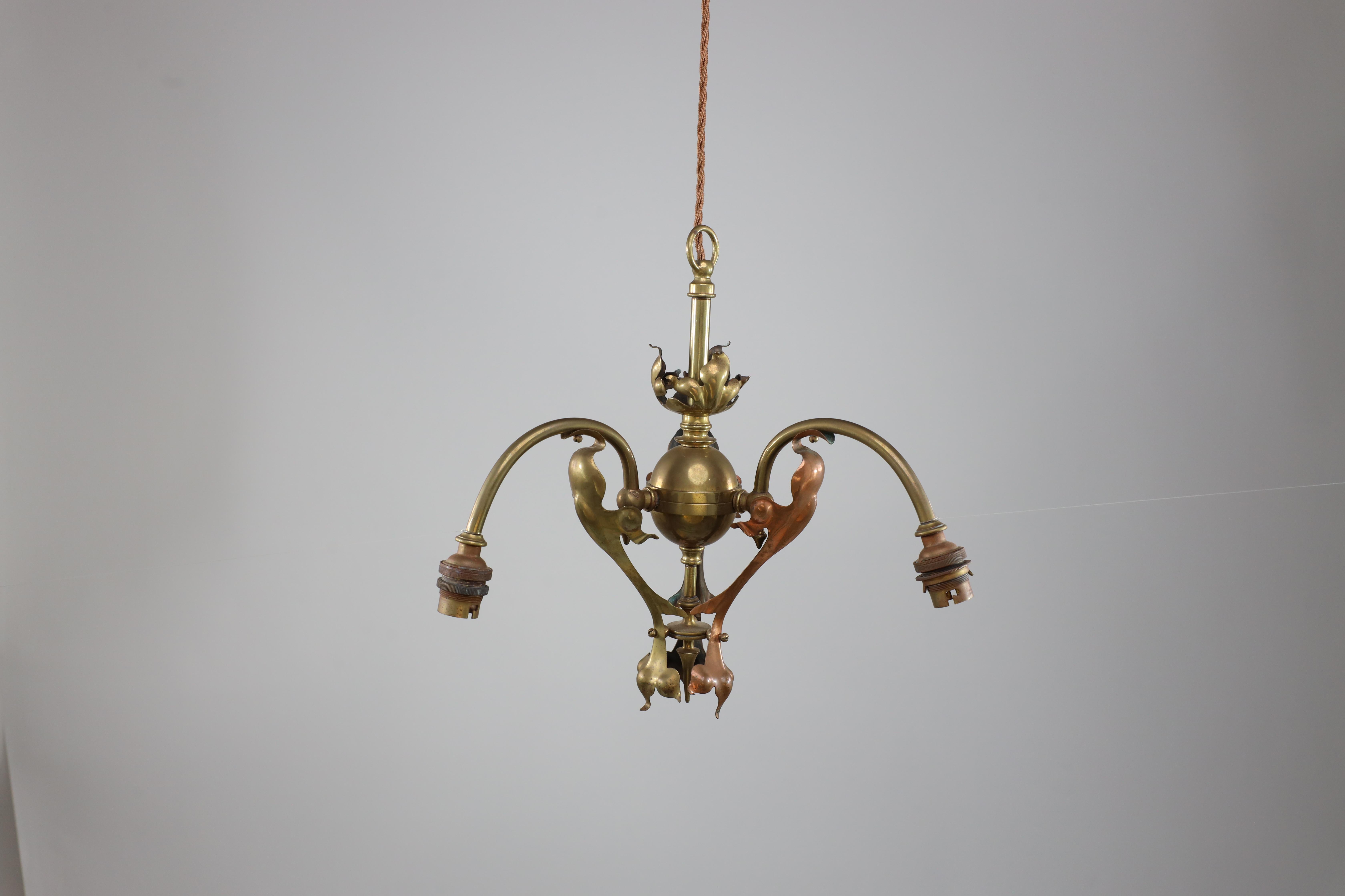 English An Arts and Crafts brass three arm ceiling light with a flower bud to the top For Sale