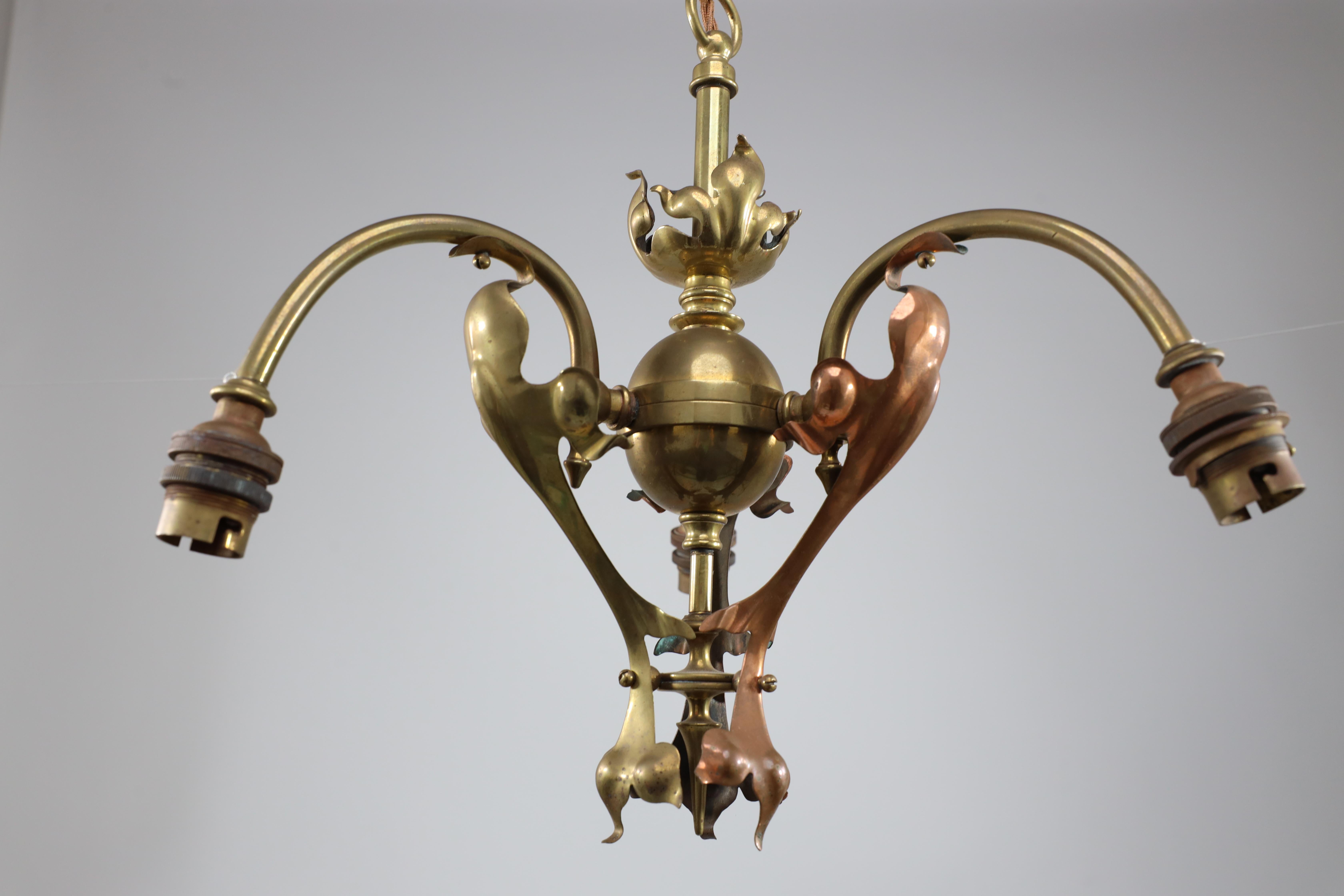 An Arts and Crafts brass three arm ceiling light with a flower bud to the top In Good Condition For Sale In London, GB