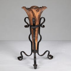 An Arts and Crafts copper and hand wrought iron conical flower vase