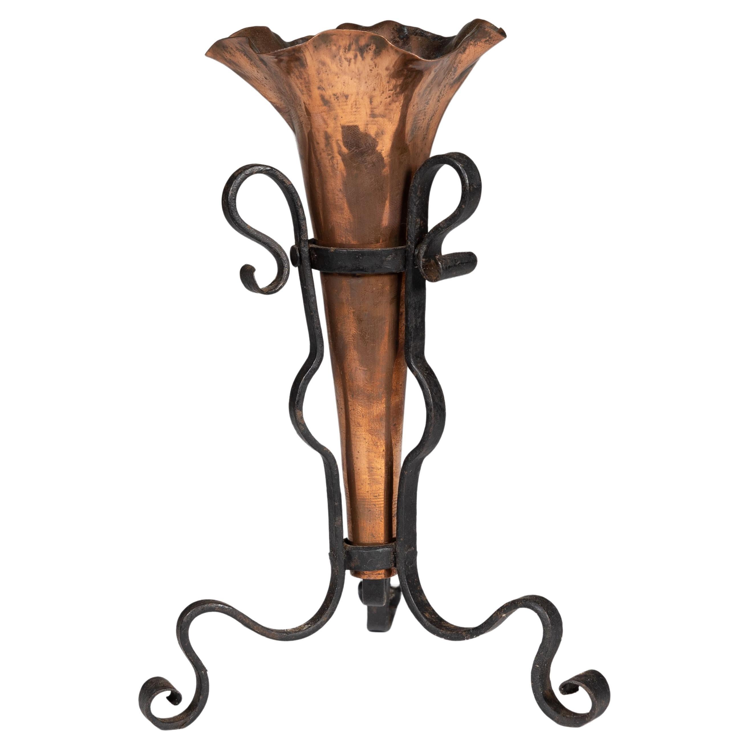 An Arts and Crafts copper and hand wrought iron conical flower vase