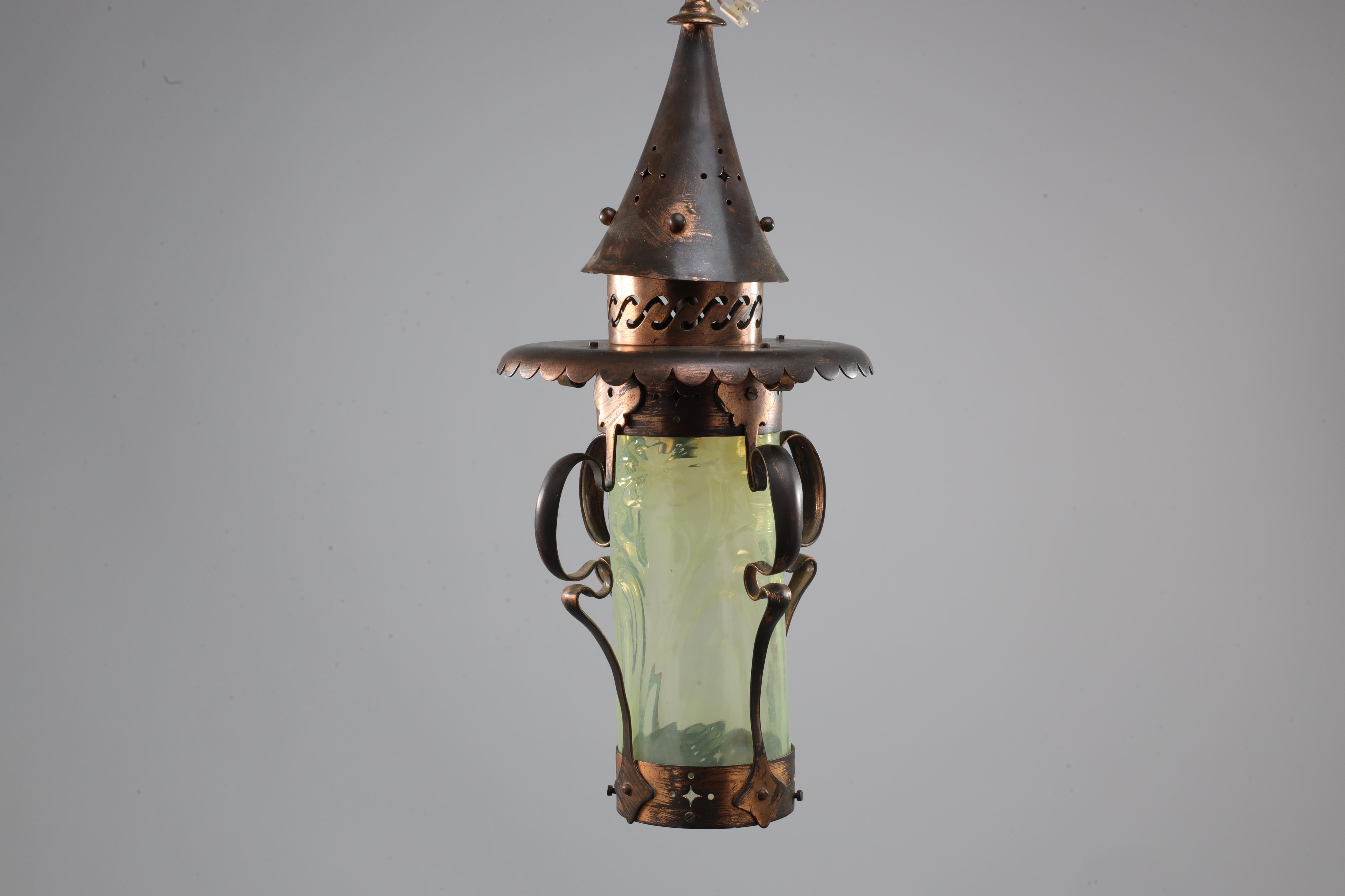 An Arts and Crafts copper & Vaseline lantern with floral flowing decoration with the original Vaseline shade with flowers in the glass. We have an original brass chain to hang this at any height.