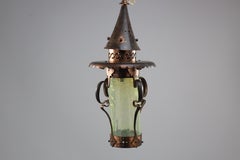 An Arts and Crafts copper & Vaseline lantern with floral flowing decoration