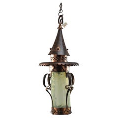 An Arts and Crafts copper & Vaseline lantern with floral flowing decoration
