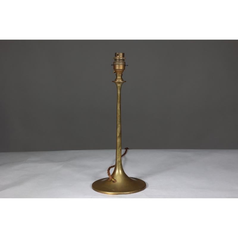 Dryad in the style of. A simple Arts & Crafts brass table lamp with a wide flaring circular base.
