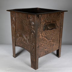 An Arts and Crafts Glasgow School copper coal box with floral decoration