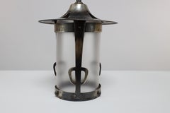 An Arts and Crafts Glasgow School hand hammered copper lantern with flaring top.