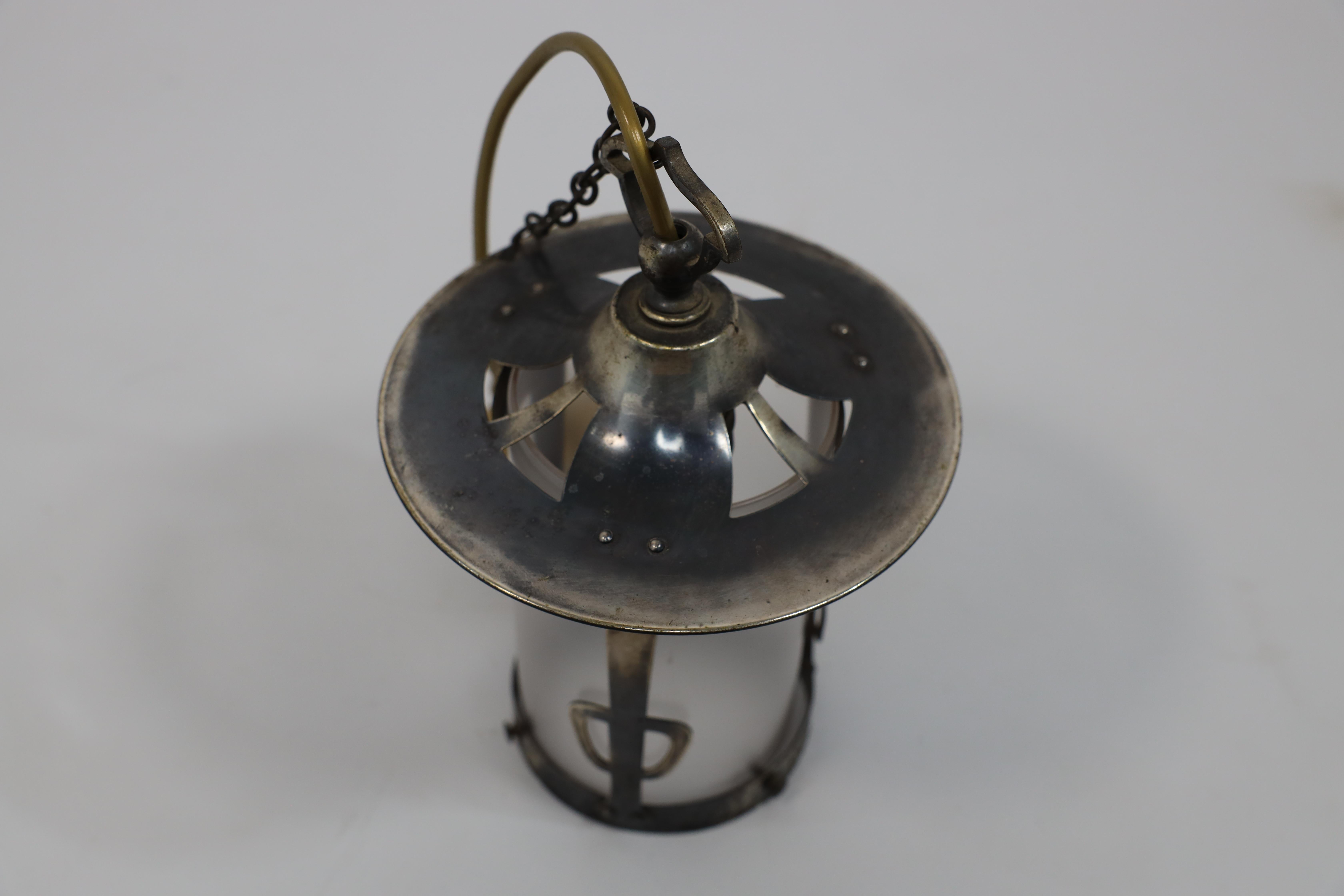 English An Arts and Crafts Glasgow School hand hammered copper lantern with flaring top. For Sale