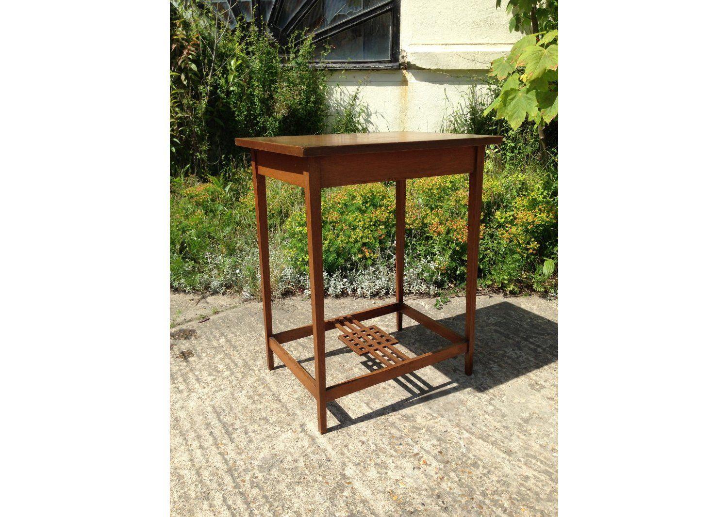 An Arts and Crafts Glasgow style oak side table with square details to the lower stretchers. 
Height 28 3/4, Depth 23 1/2, Width 17 1/2