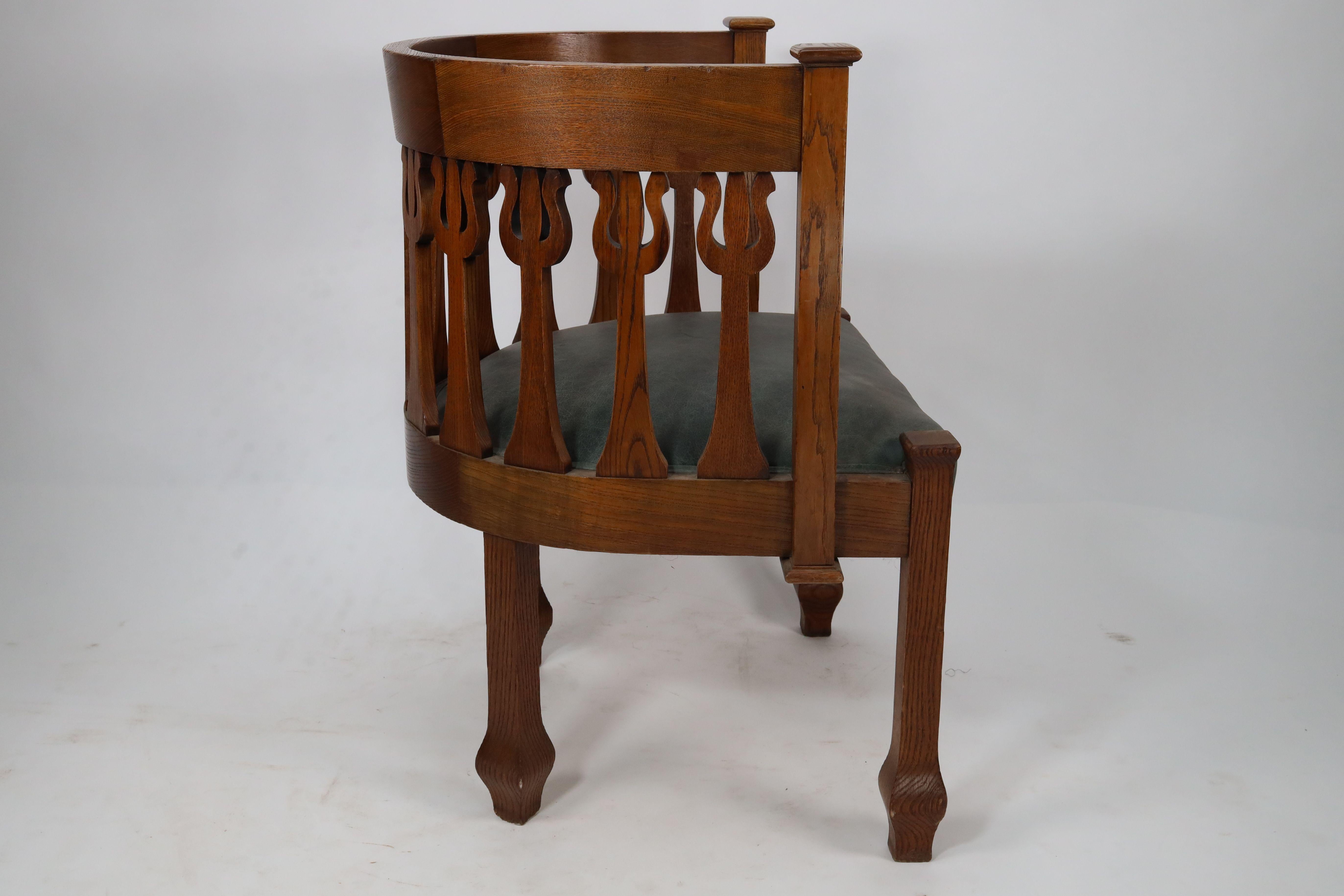 English An Arts and Crafts oak armchair with stylized floral upright decoration For Sale