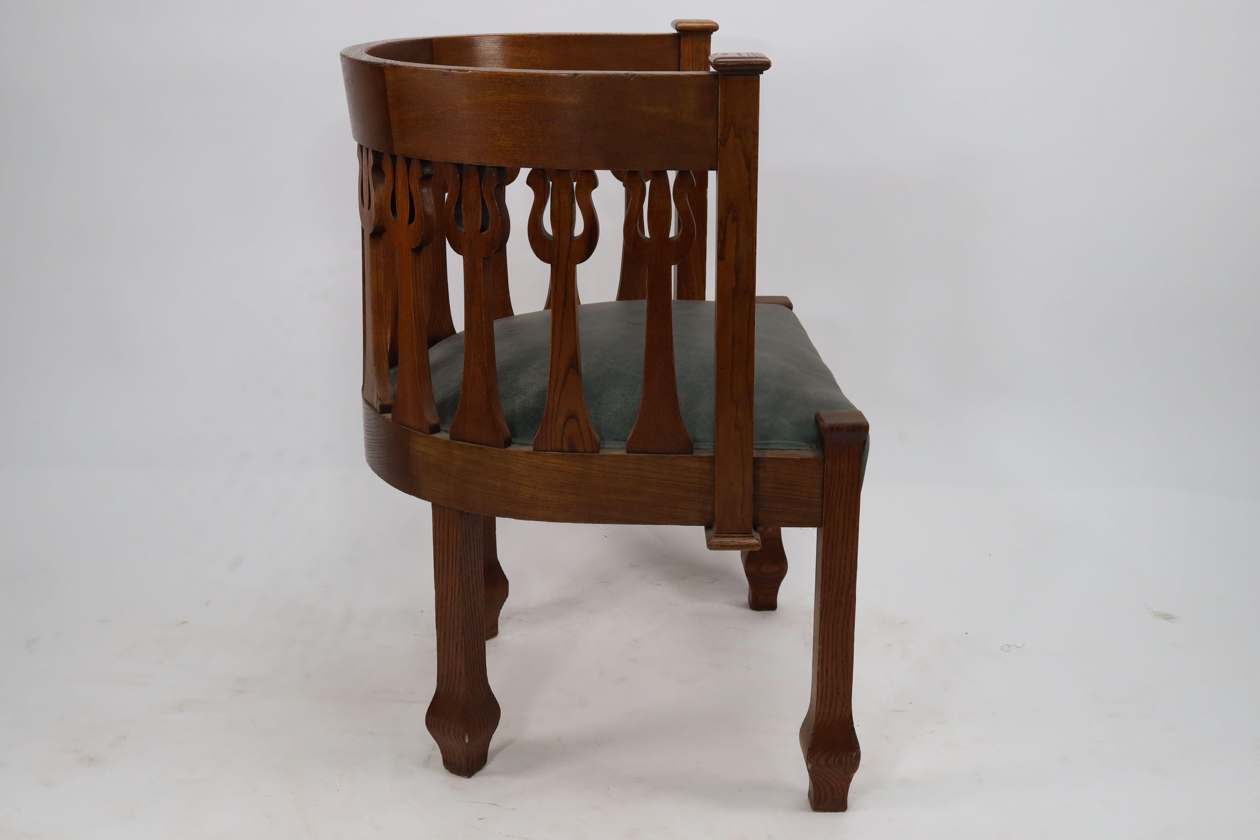 Leather An Arts and Crafts oak armchair with stylized floral upright decoration For Sale