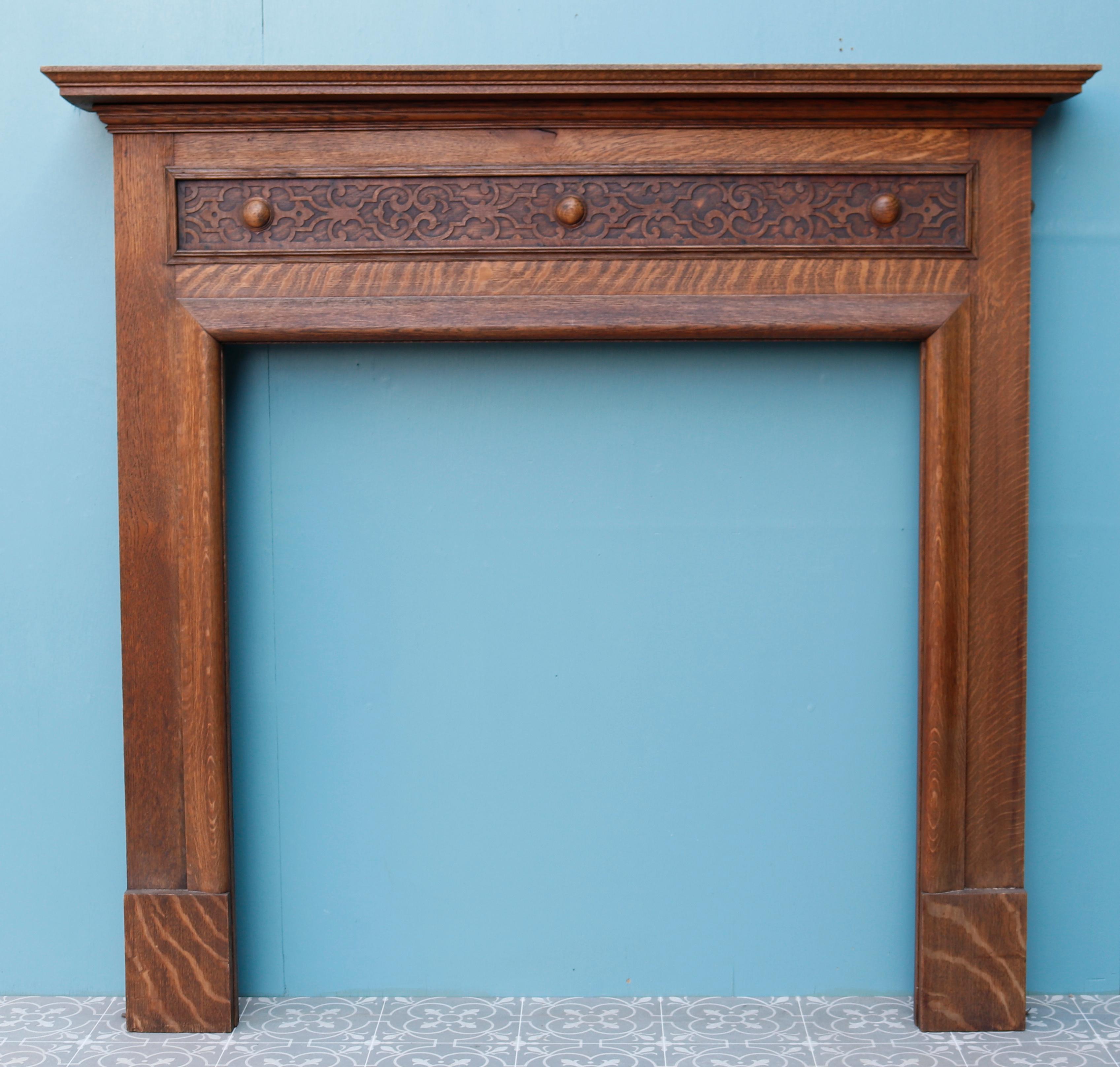 An antique oak fire surround with a carved frieze in the Arts and Crafts style.

Additional dimensions 

Opening height 96 cm

Opening width 95 cm

Width between outsides of the foot blocks 125.5 cm.