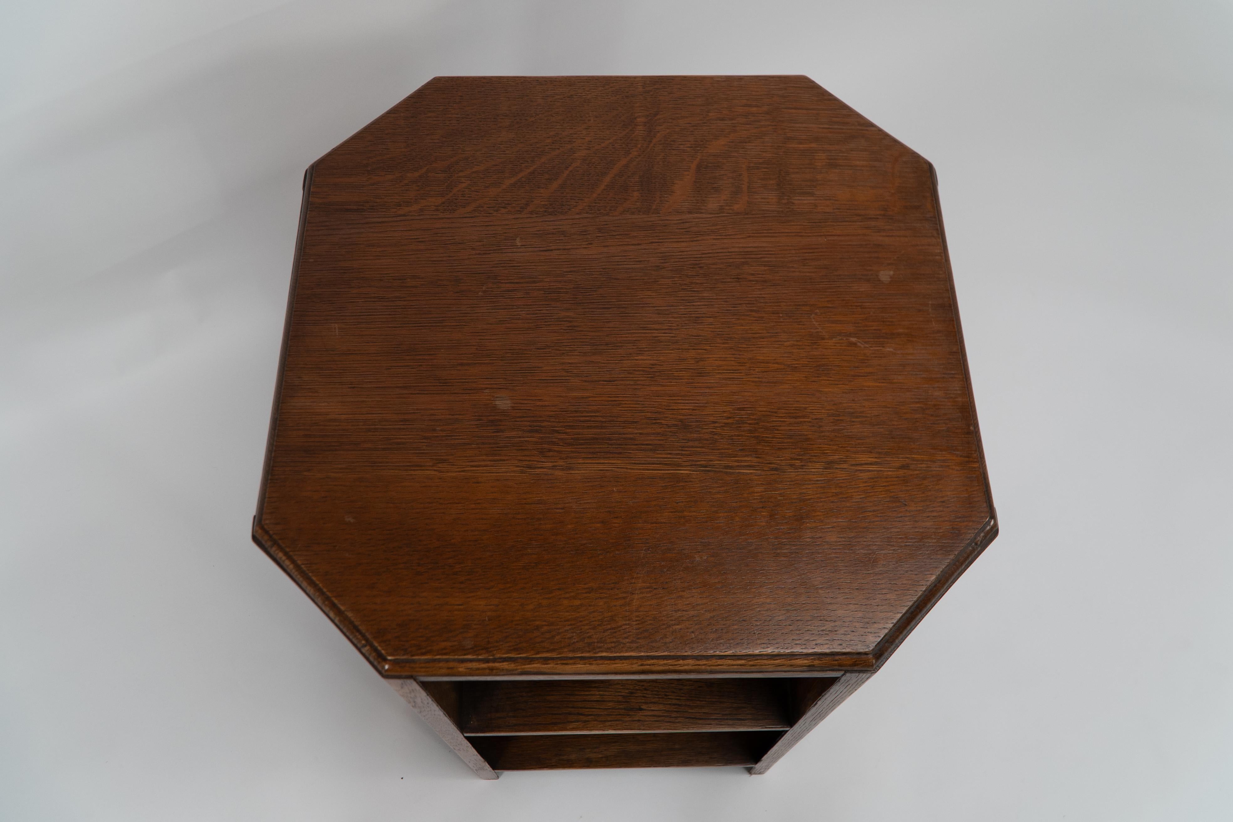 English Heals. Arts & Crafts oak octagonal coffee or side table with lower book shelves.