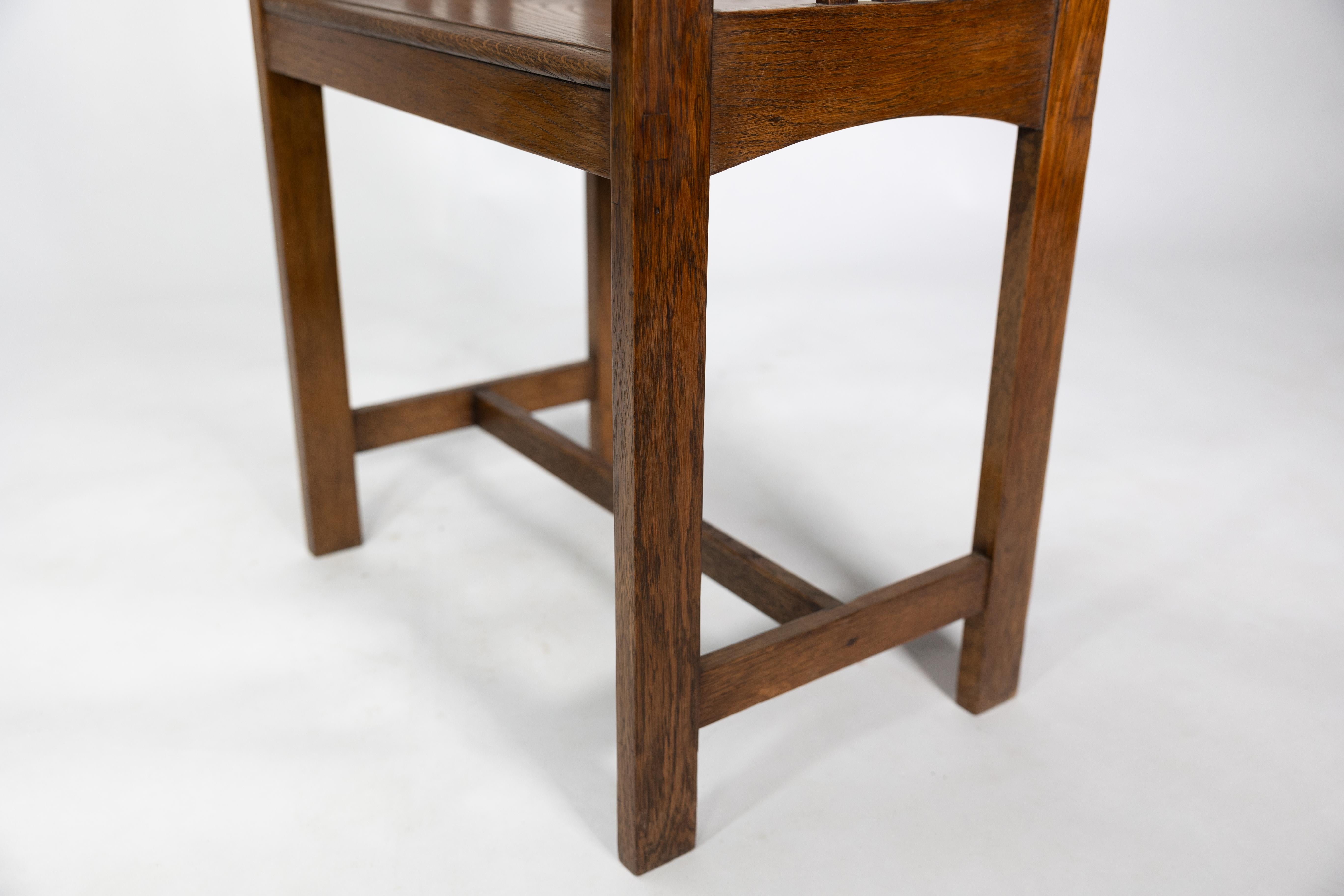 An Arts and Crafts oak piano stool with raised sides 4