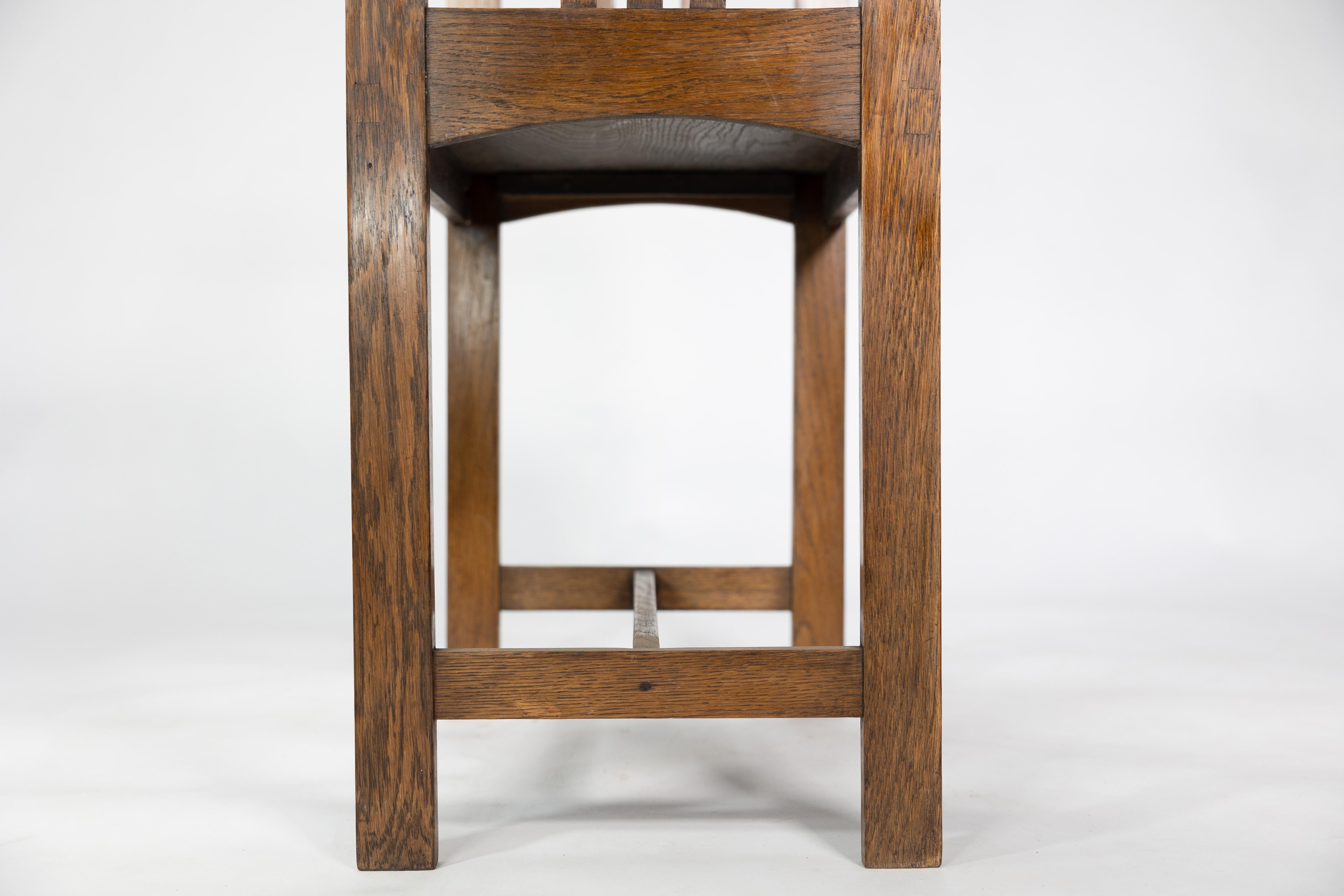 An Arts and Crafts oak piano stool with raised sides 6
