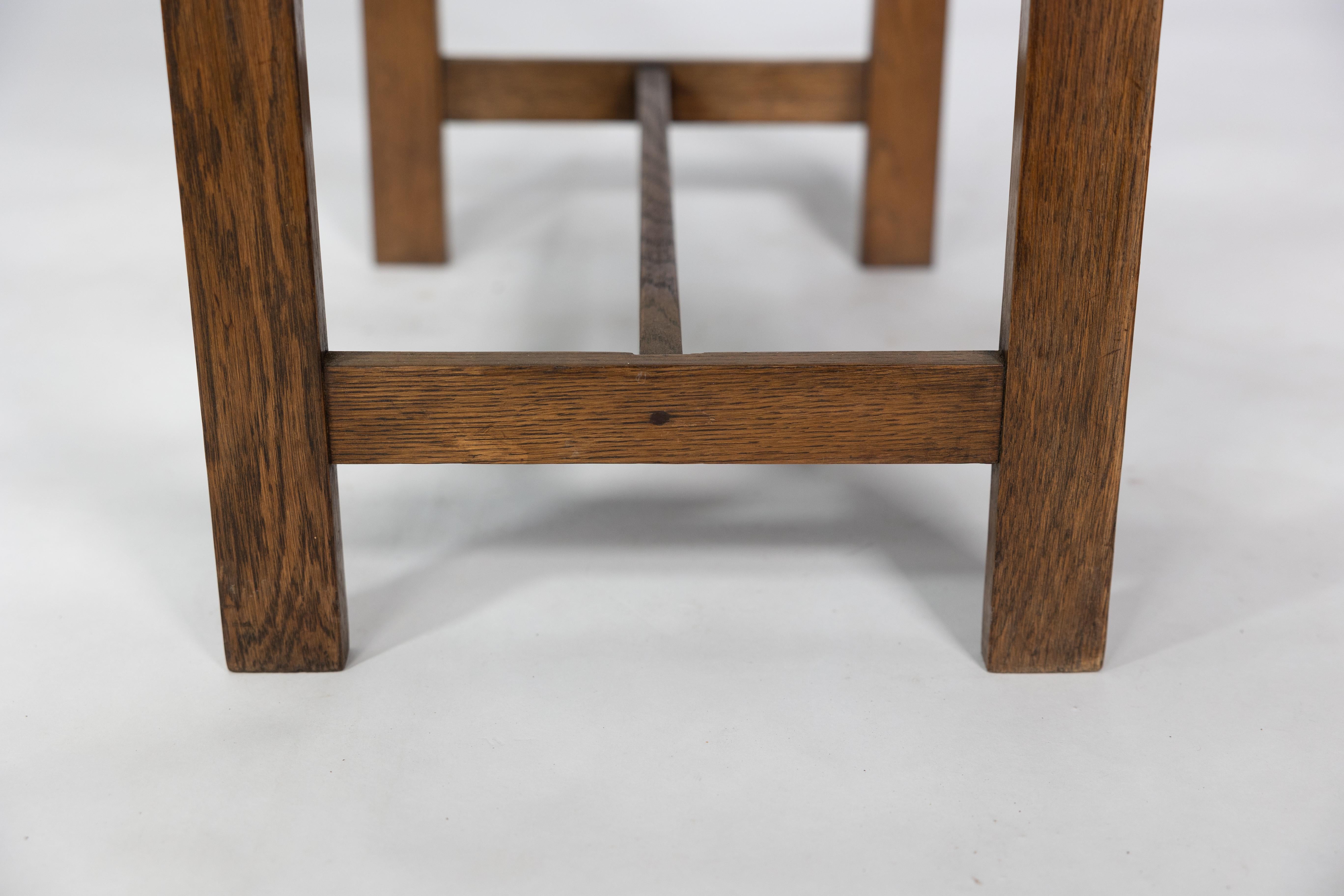 An Arts and Crafts oak piano stool with raised sides 7