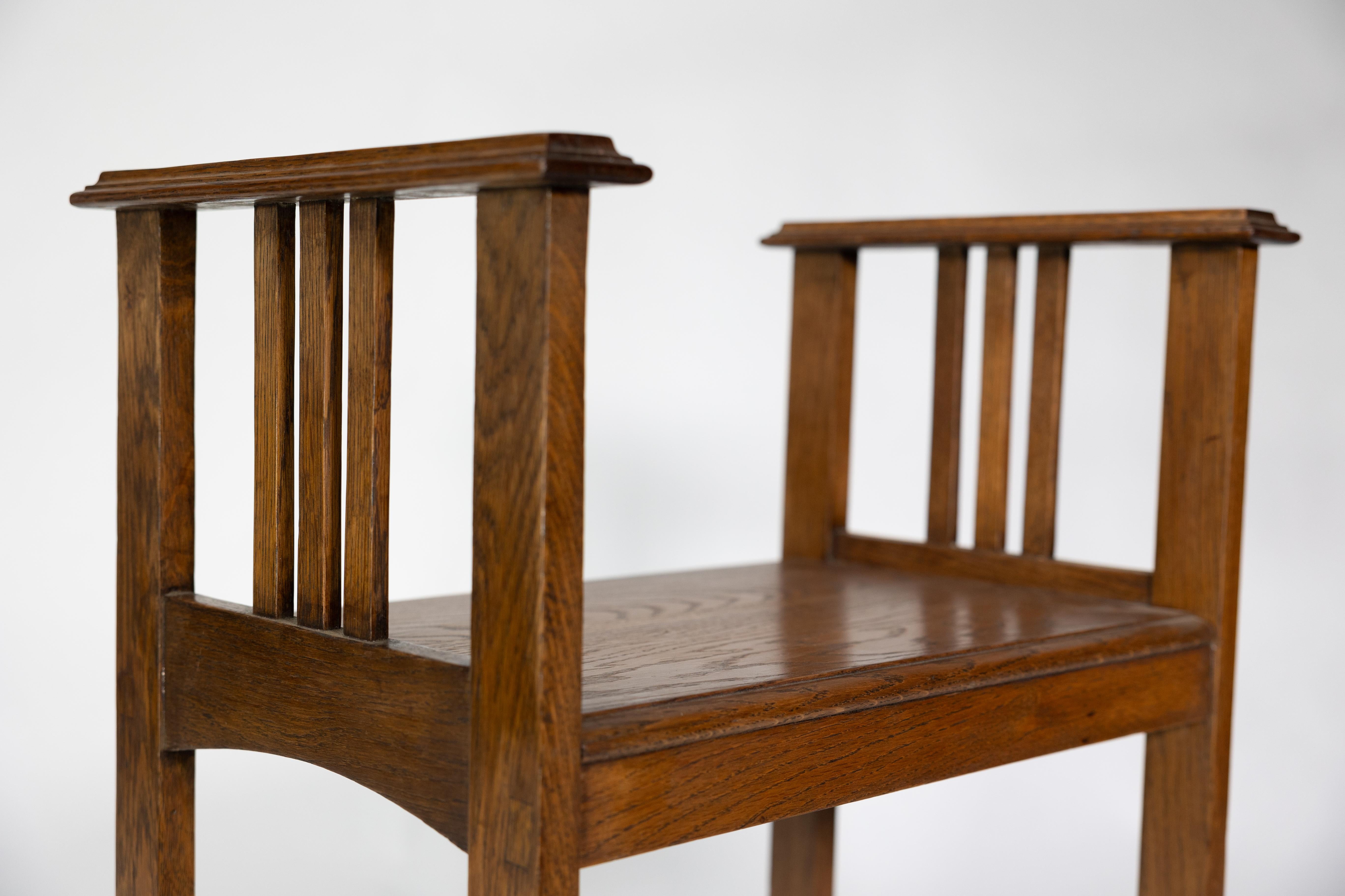 An Arts and Crafts oak piano stool with raised sides 10