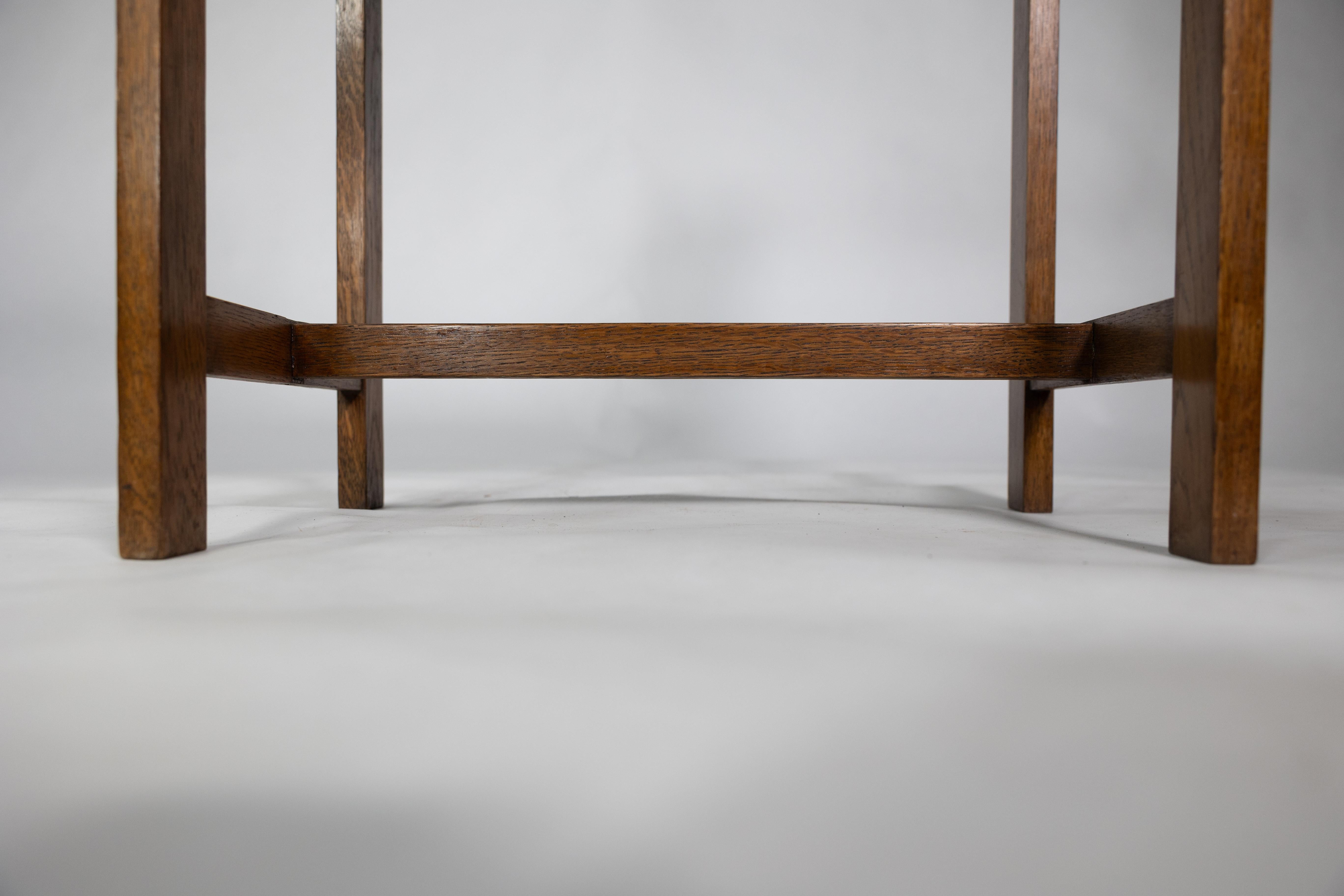 An Arts and Crafts oak piano stool with raised sides 12