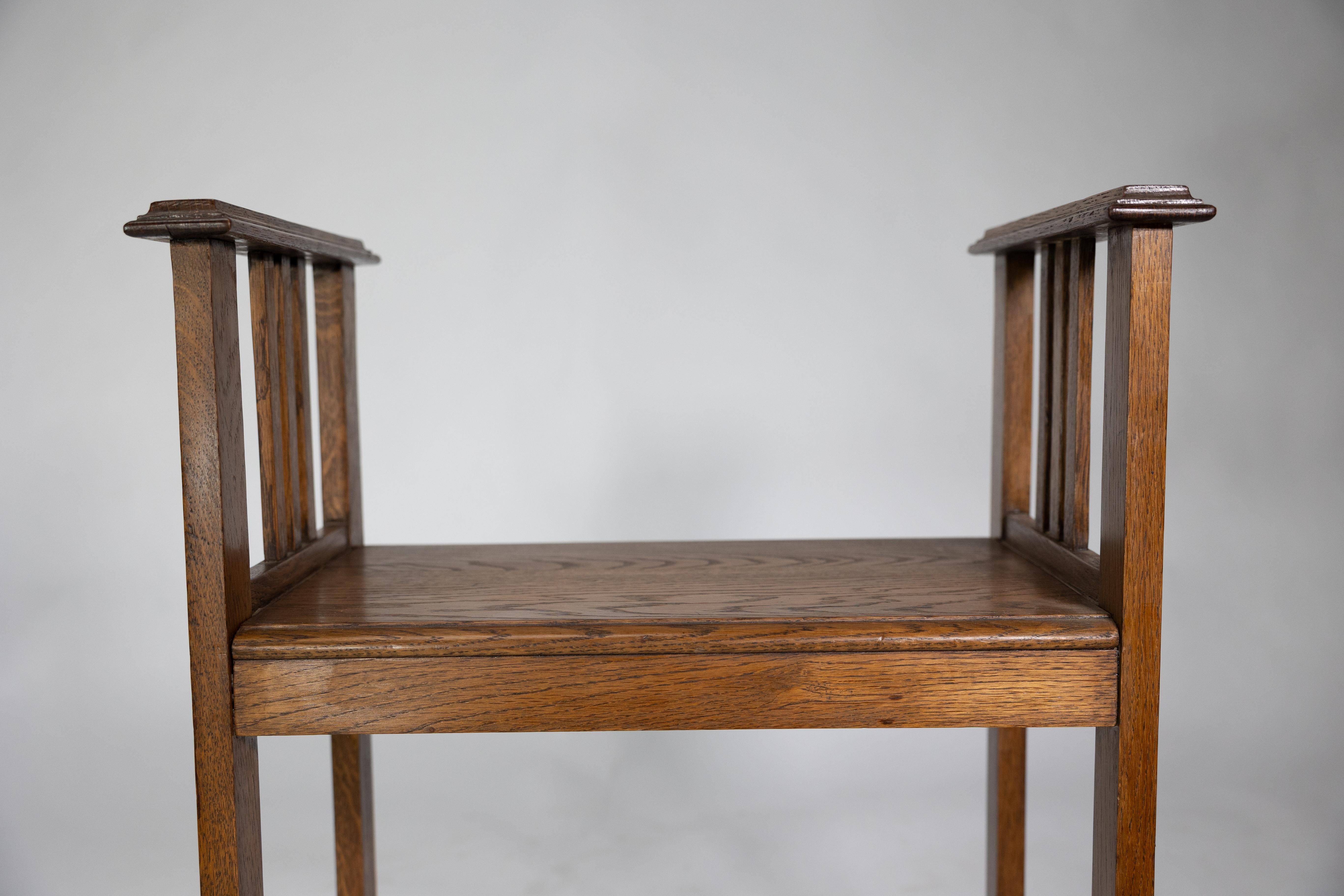 An Arts and Crafts oak piano stool with raised sides 13