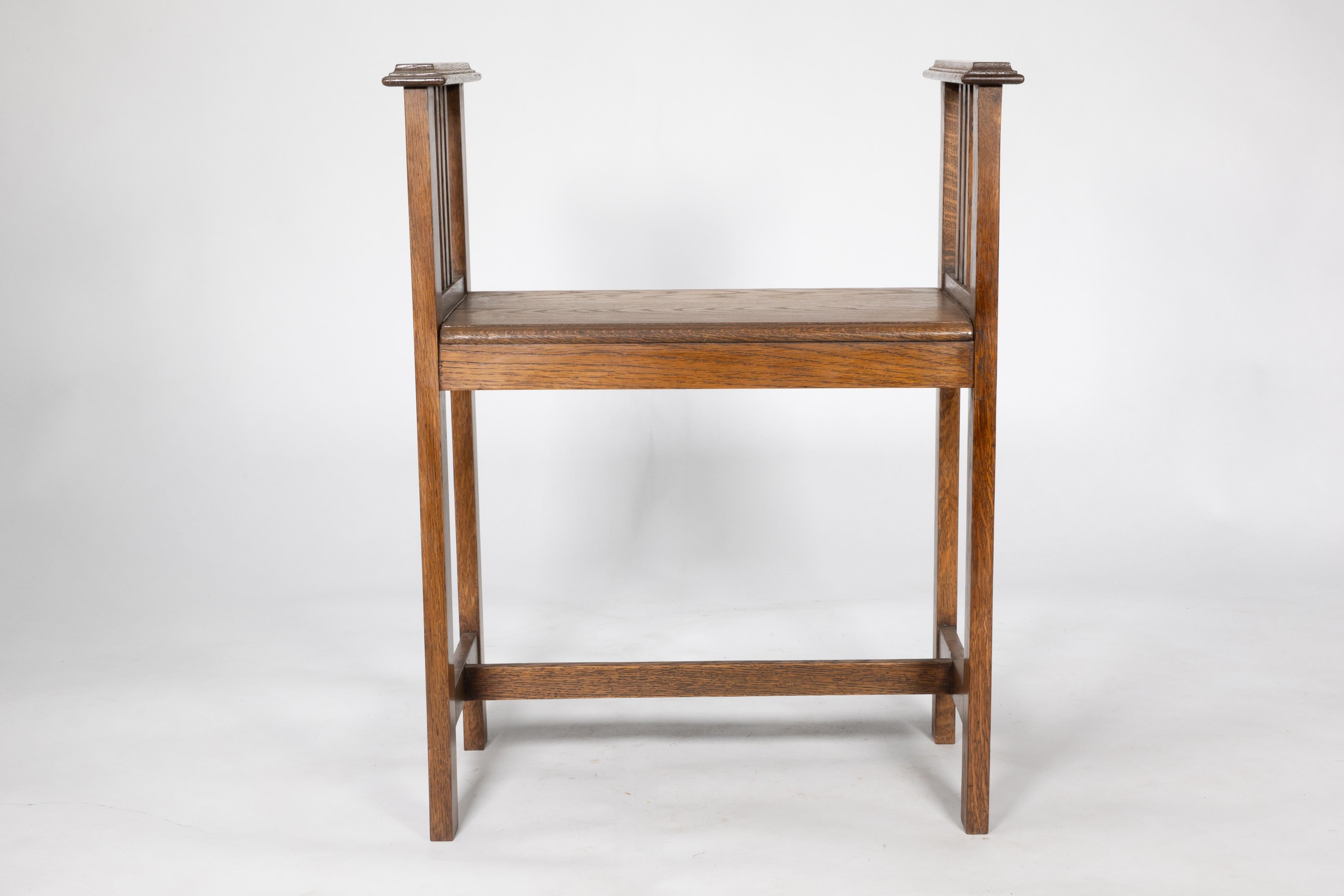 Early 20th Century An Arts and Crafts oak piano stool with raised sides