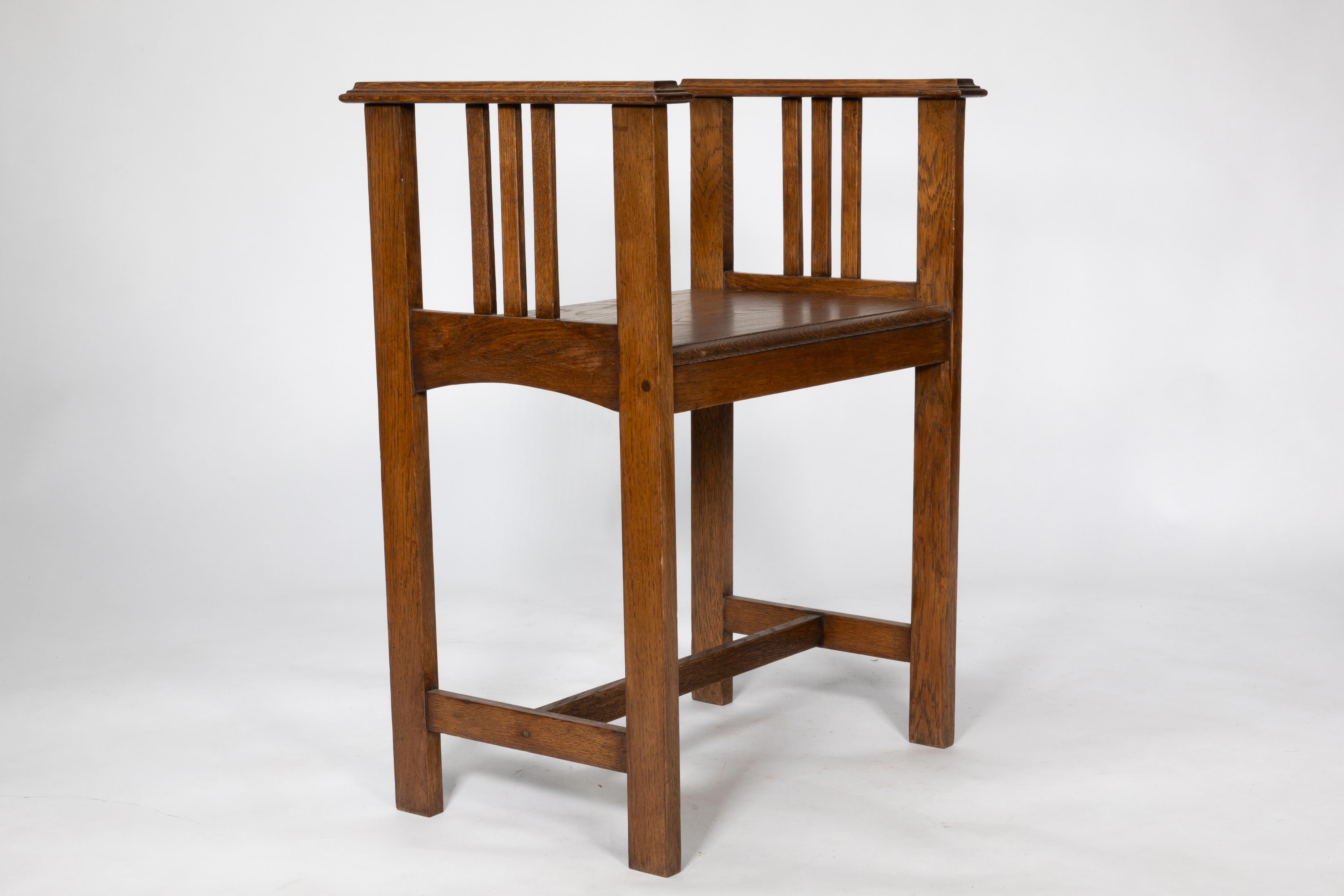 Oak An Arts and Crafts oak piano stool with raised sides