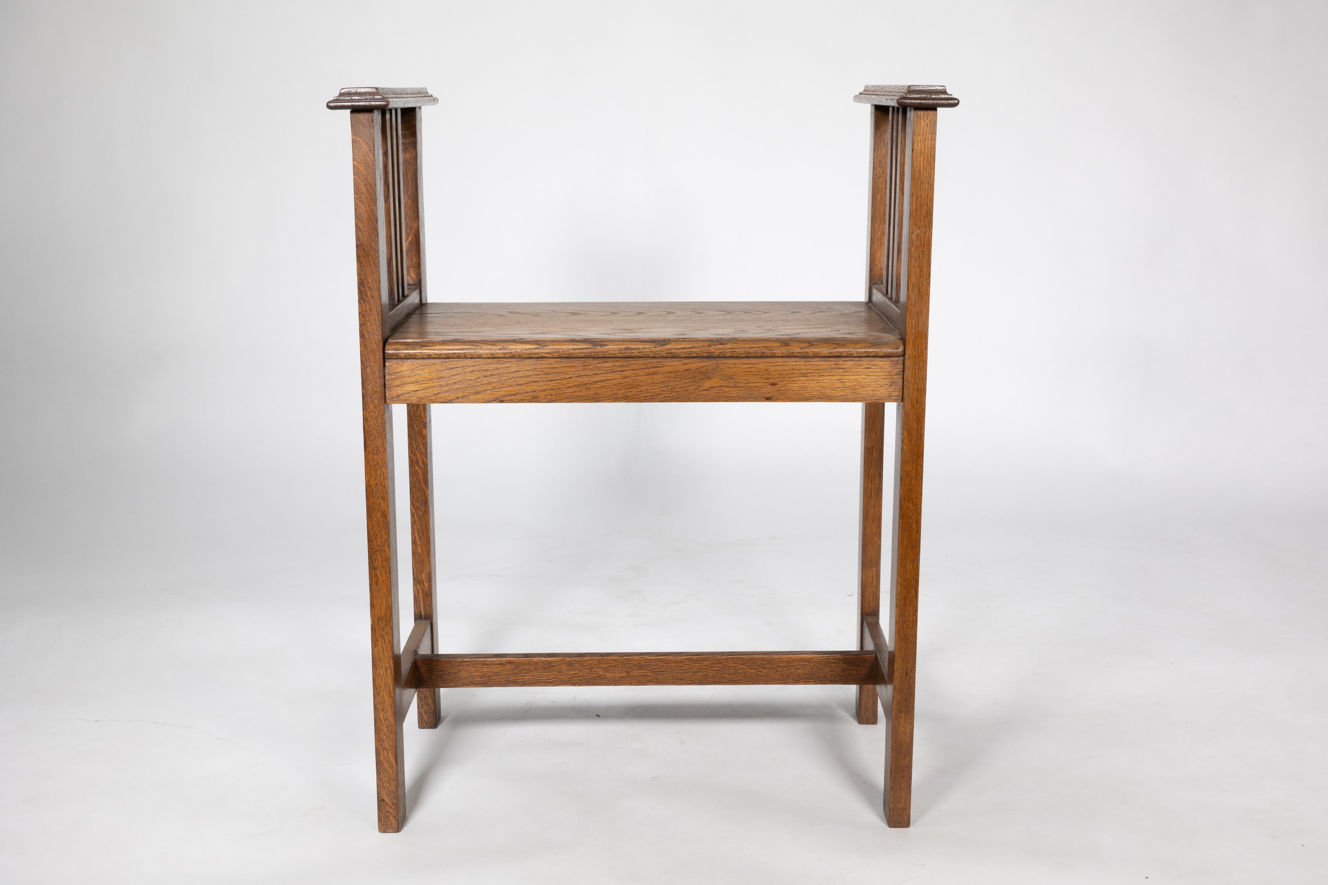 An Arts and Crafts oak piano stool with raised sides 3