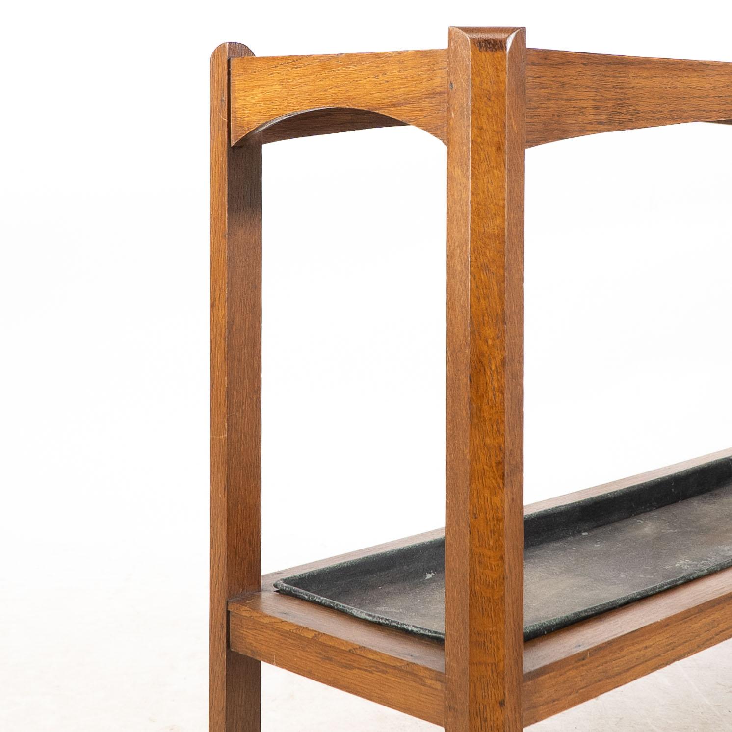 An Arts and Crafts oak stick and umbrella stand with fourteen sections For Sale 4