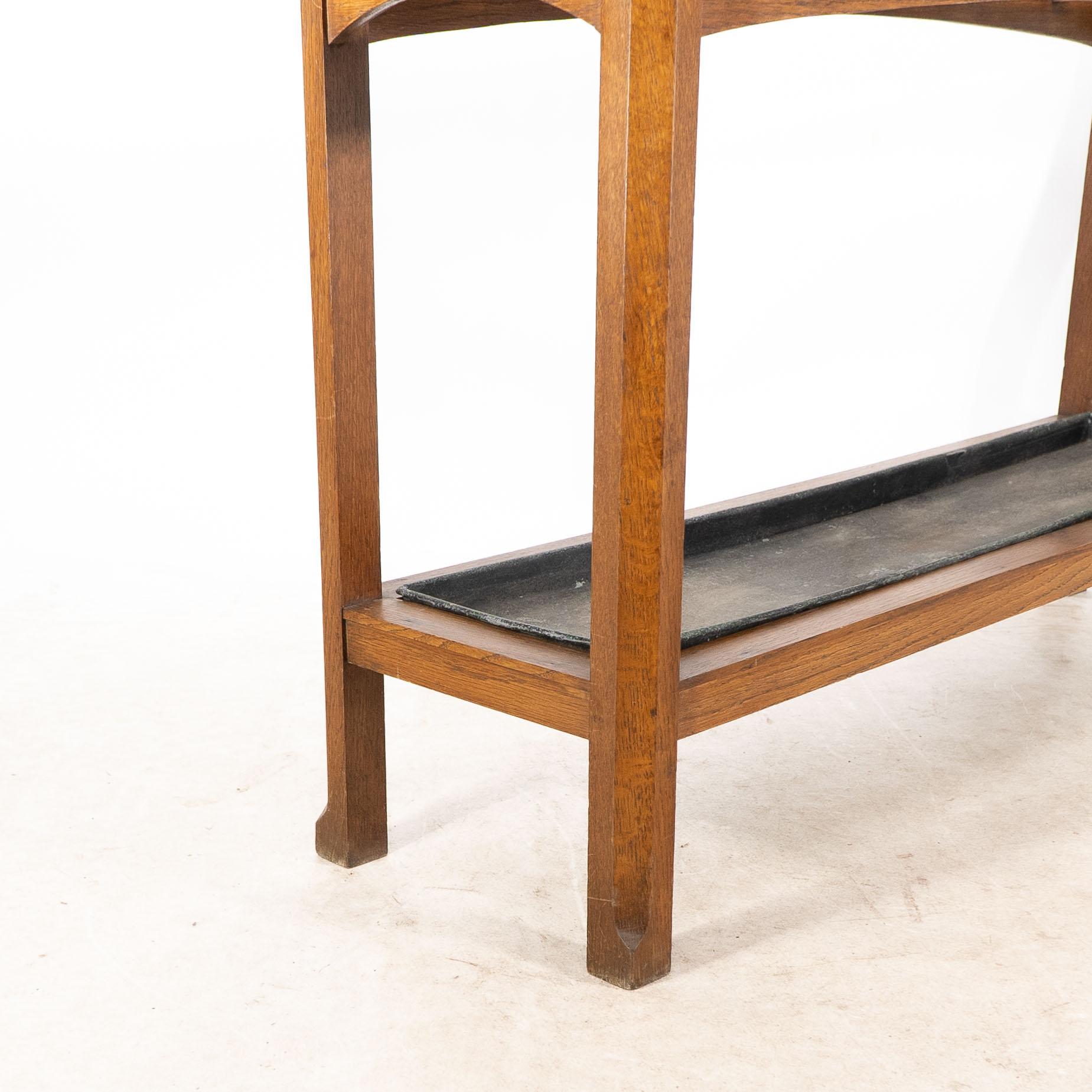 An Arts and Crafts oak stick and umbrella stand with fourteen sections For Sale 5