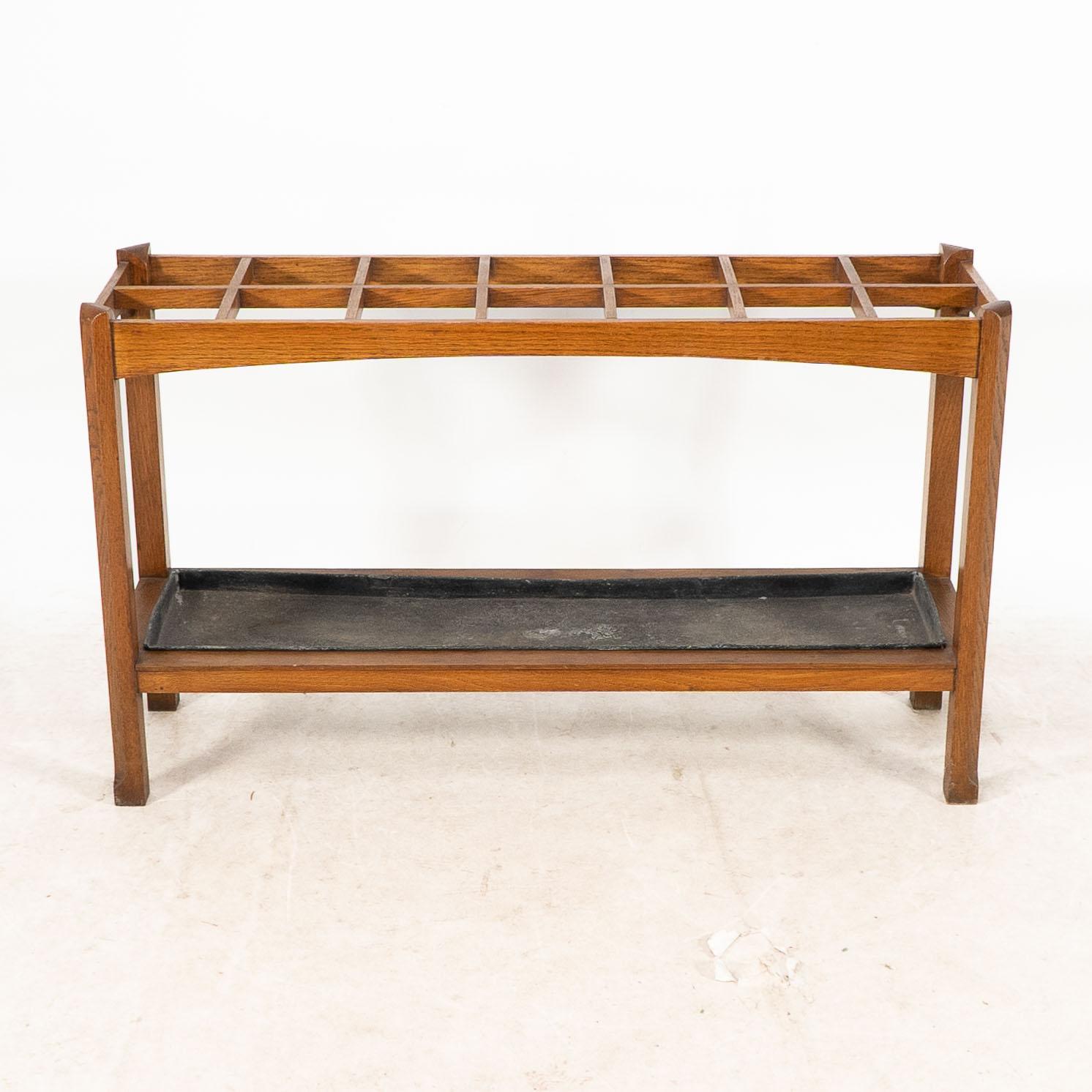 Early 20th Century An Arts and Crafts oak stick and umbrella stand with fourteen sections For Sale