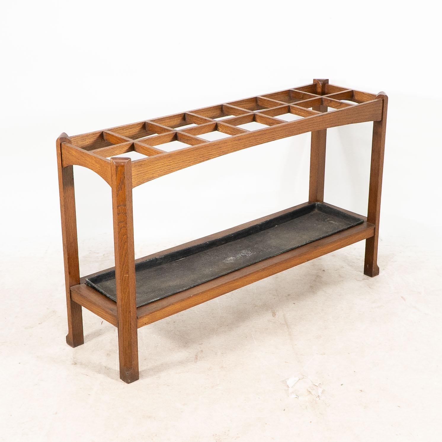 Oak An Arts and Crafts oak stick and umbrella stand with fourteen sections For Sale